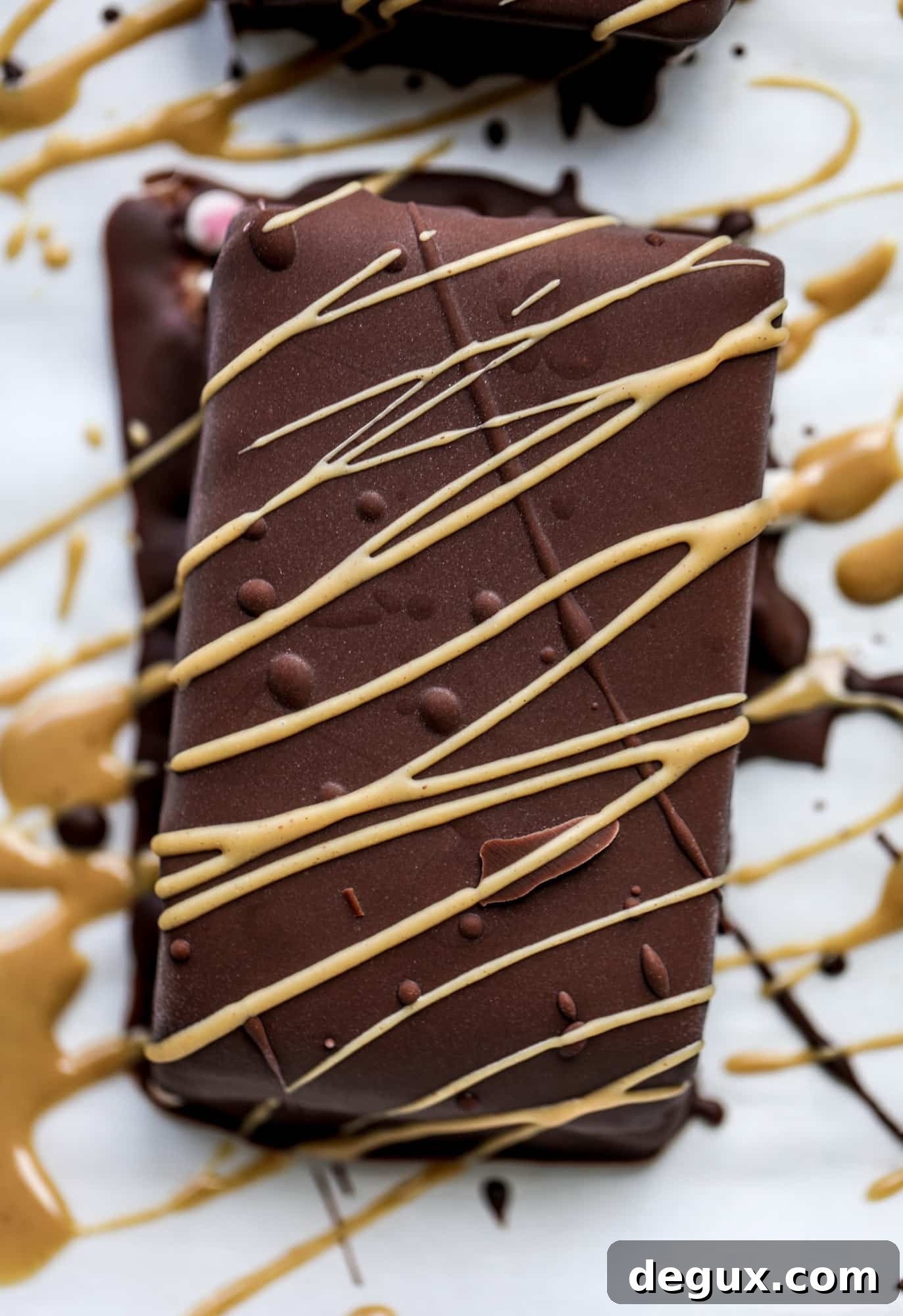 These frozen peanut butter jelly bars are super easy and made with an oatmilk frozen dessert, then covered in a dark chocolate shell. Delish!