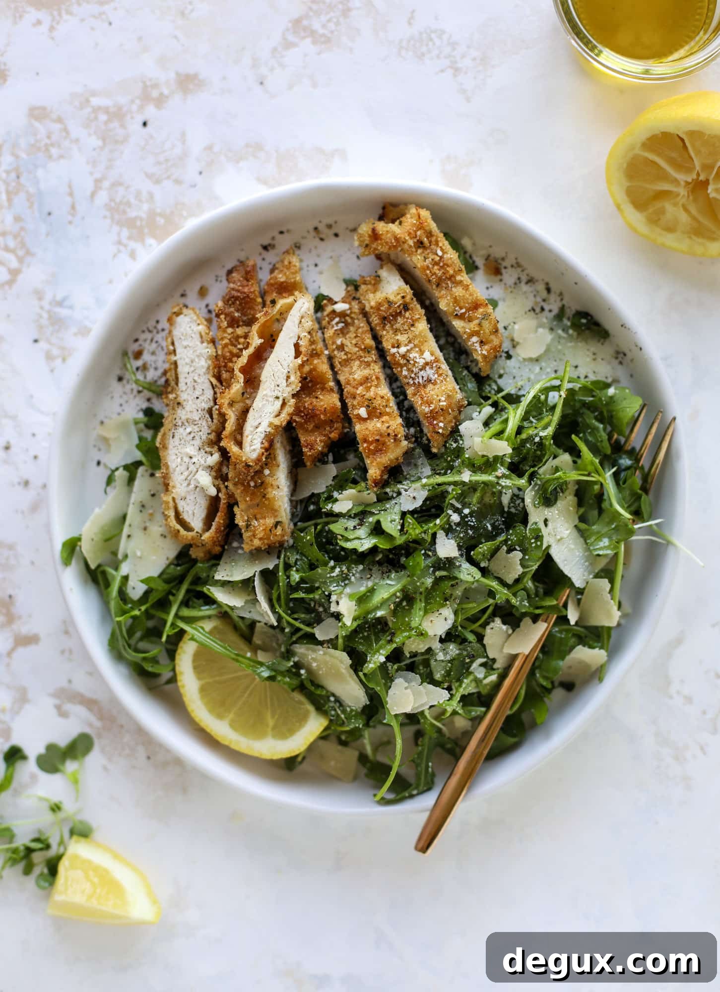 Crispy Baked Parmesan Chicken with Lemon Arugula Salad 7 Crispy baked parmesan chicken is so super easy and delicious! It's an amazing weeknight meal served with a lemon arugula salad. Delish!