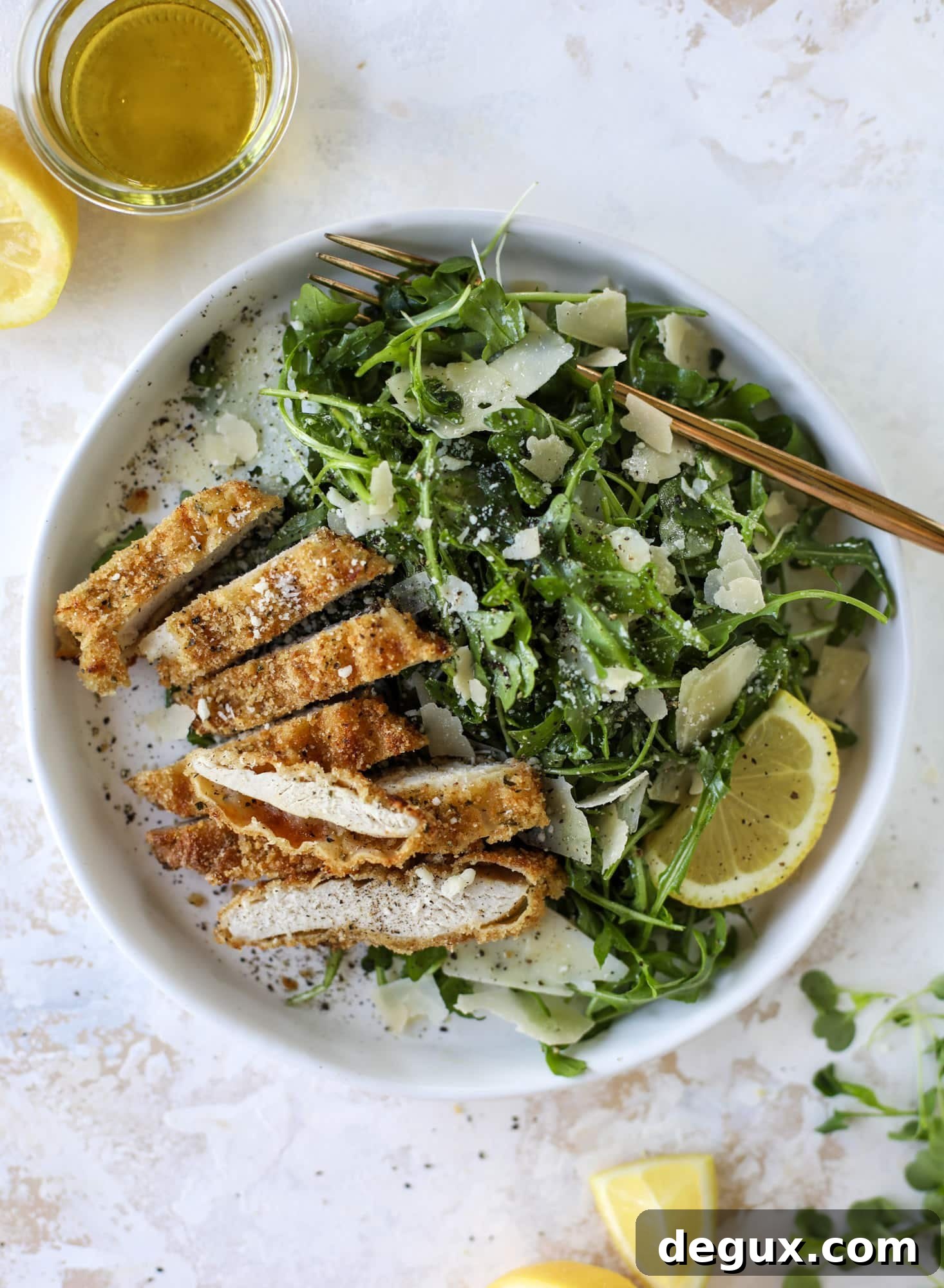 Crispy Baked Parmesan Chicken with Lemon Arugula Salad 8 Crispy baked parmesan chicken is so super easy and delicious! It's an amazing weeknight meal served with a lemon arugula salad. Delish!