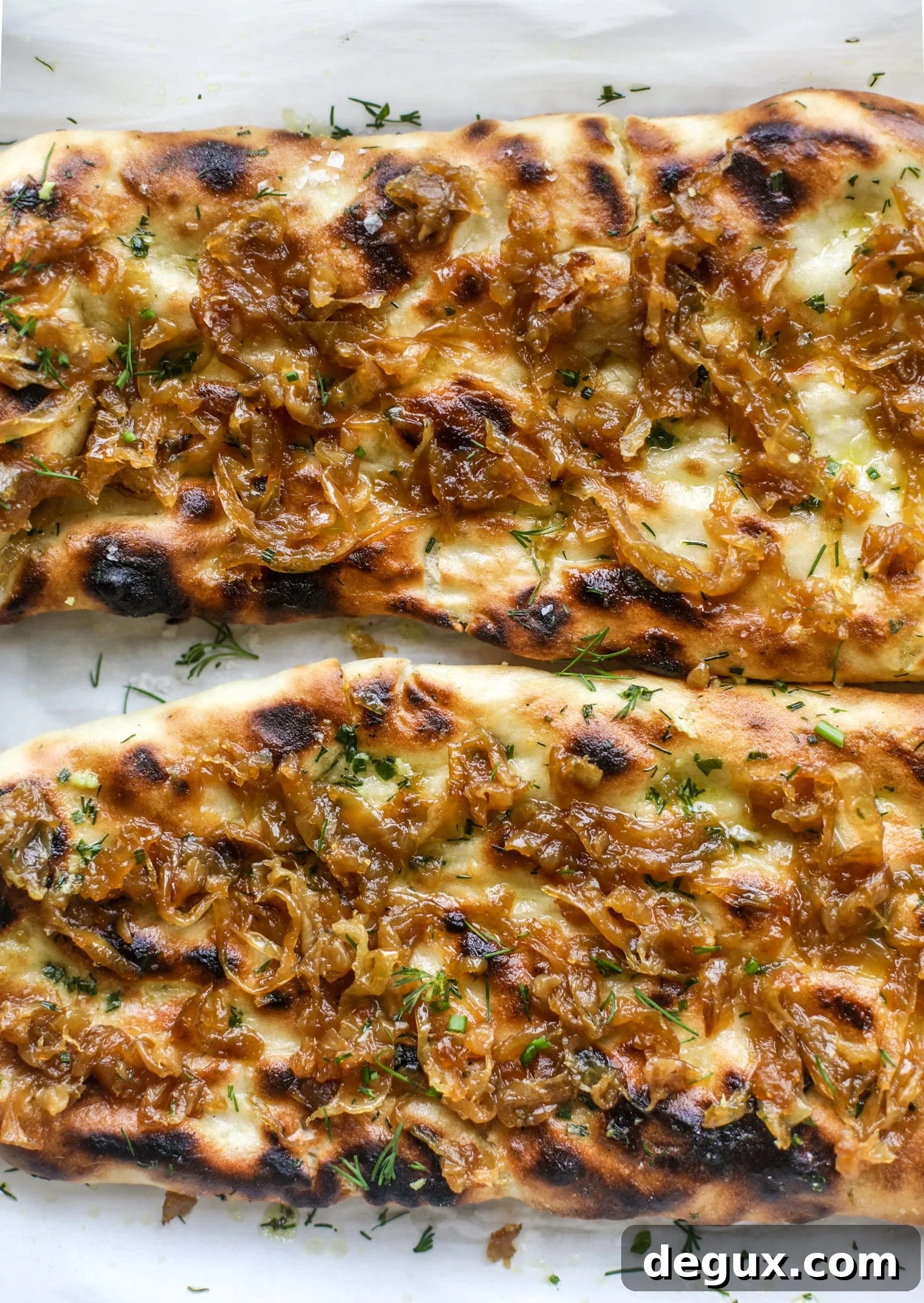 Caramelized Onion & Garlic Butter Grilled Focaccia Recipe 7 Grilled focaccia bread is such a treat! Topped with puddles of garlic butter, fresh chopped herbs and golden, caramelized onions, it's a slice of heaven.