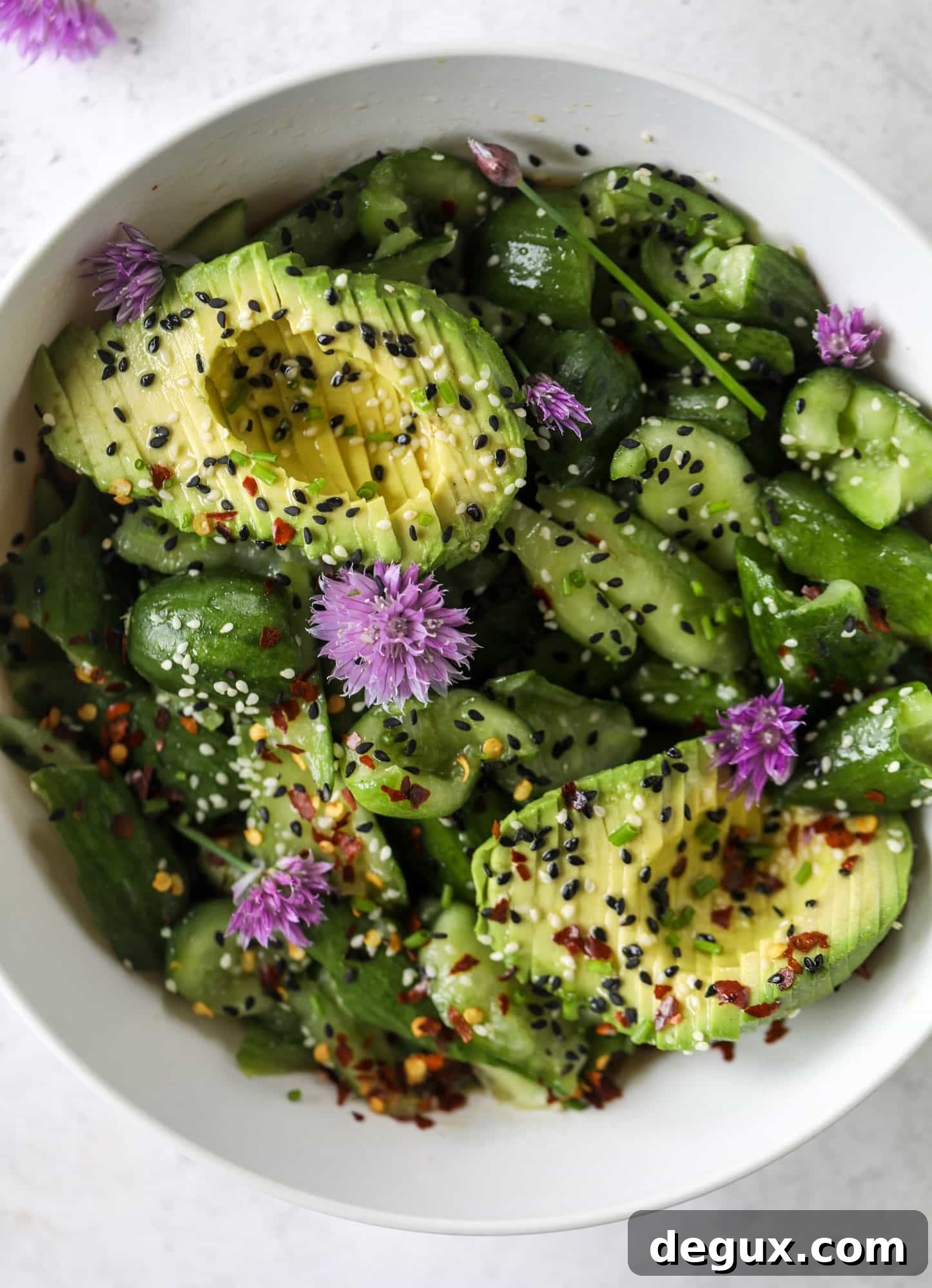 This smashed cucumber salad is so refreshing and perfect for summer! Served with avocado, toasted sesame oil and chives, it's ridiculously flavorful.
