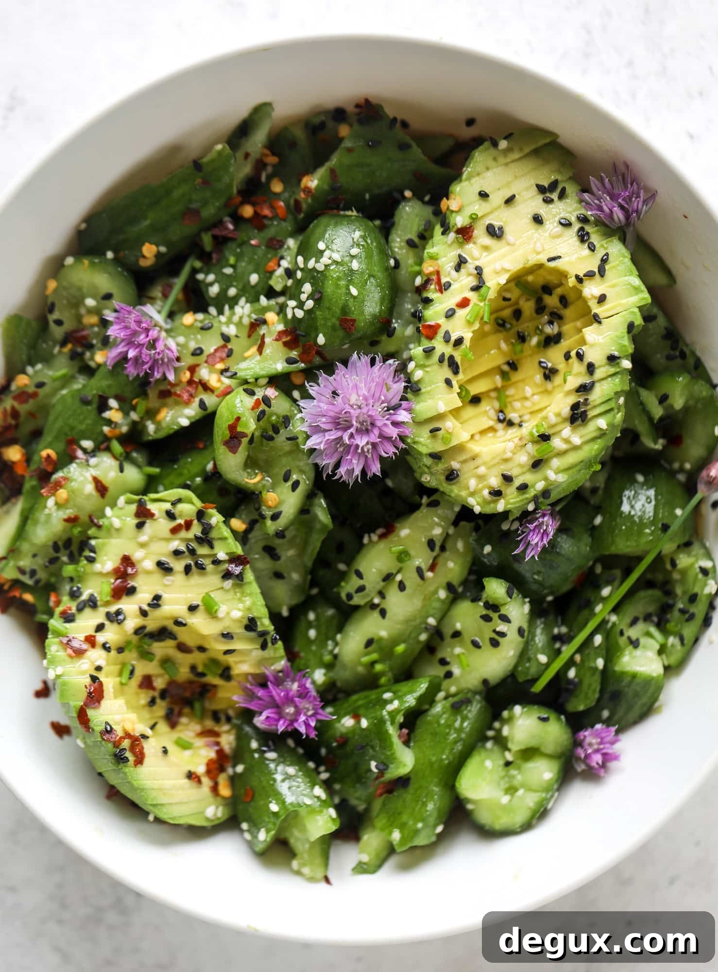 This smashed cucumber salad is so refreshing and perfect for summer! Served with avocado, toasted sesame oil and chives, it's ridiculously flavorful.