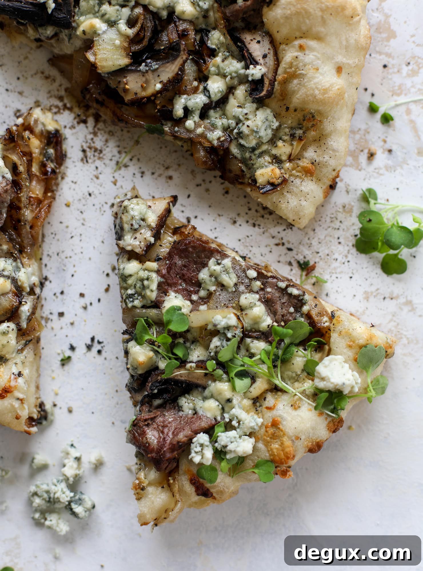 This grilled steakhouse pizza has all the amazing smoky flavors of your favorite steakhouse. Grilled onions, mushrooms and creamy gorgonzola finish it off.