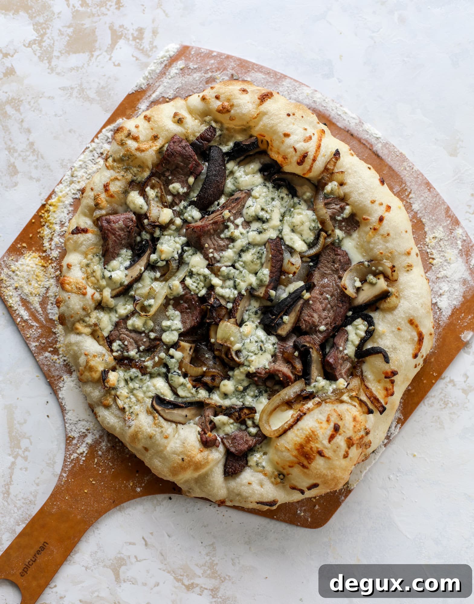 This grilled steakhouse pizza has all the amazing smoky flavors of your favorite steakhouse. Grilled onions, mushrooms and creamy gorgonzola finish it off.