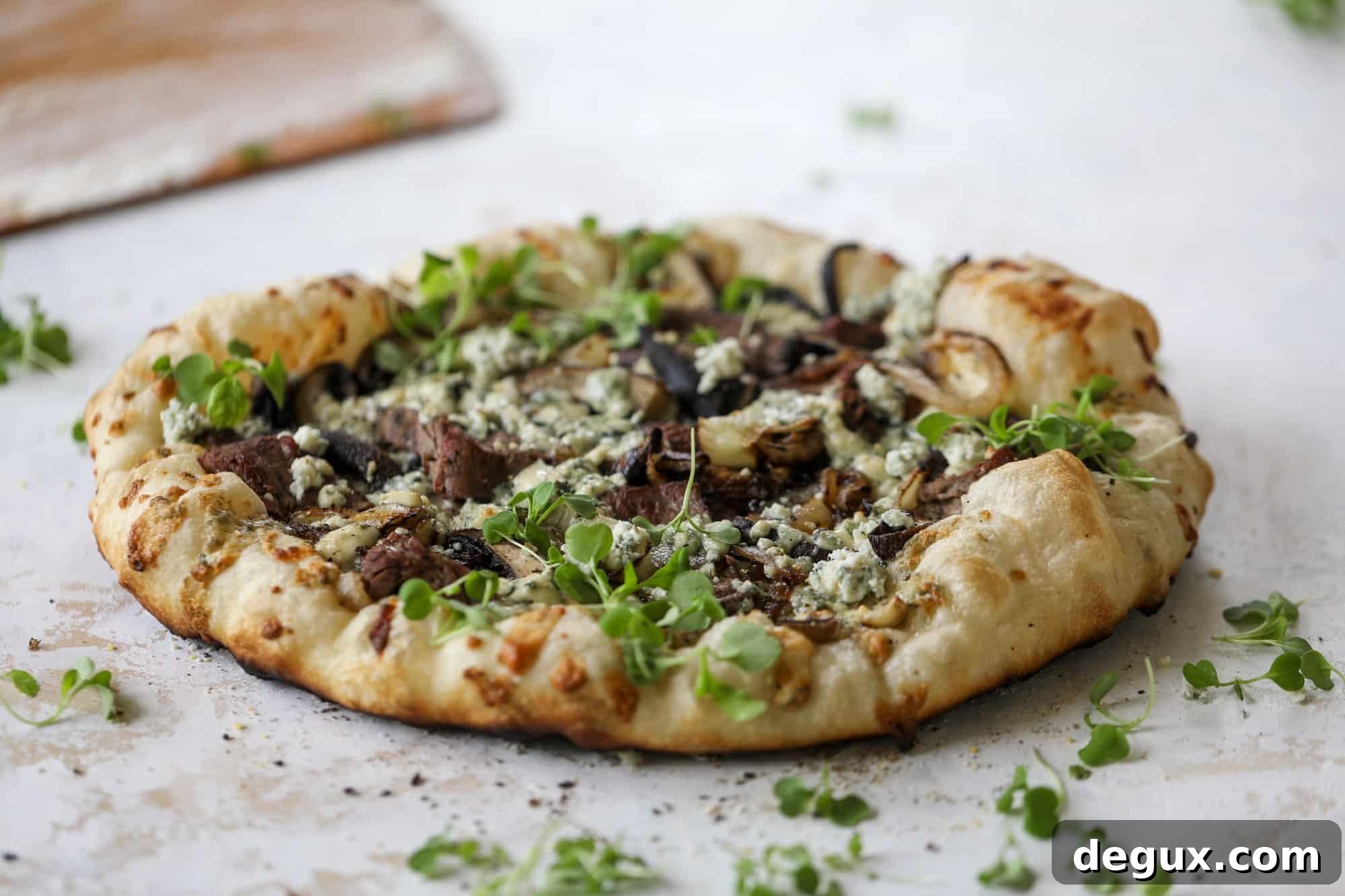 This grilled steakhouse pizza has all the amazing smoky flavors of your favorite steakhouse. Grilled onions, mushrooms and creamy gorgonzola finish it off.