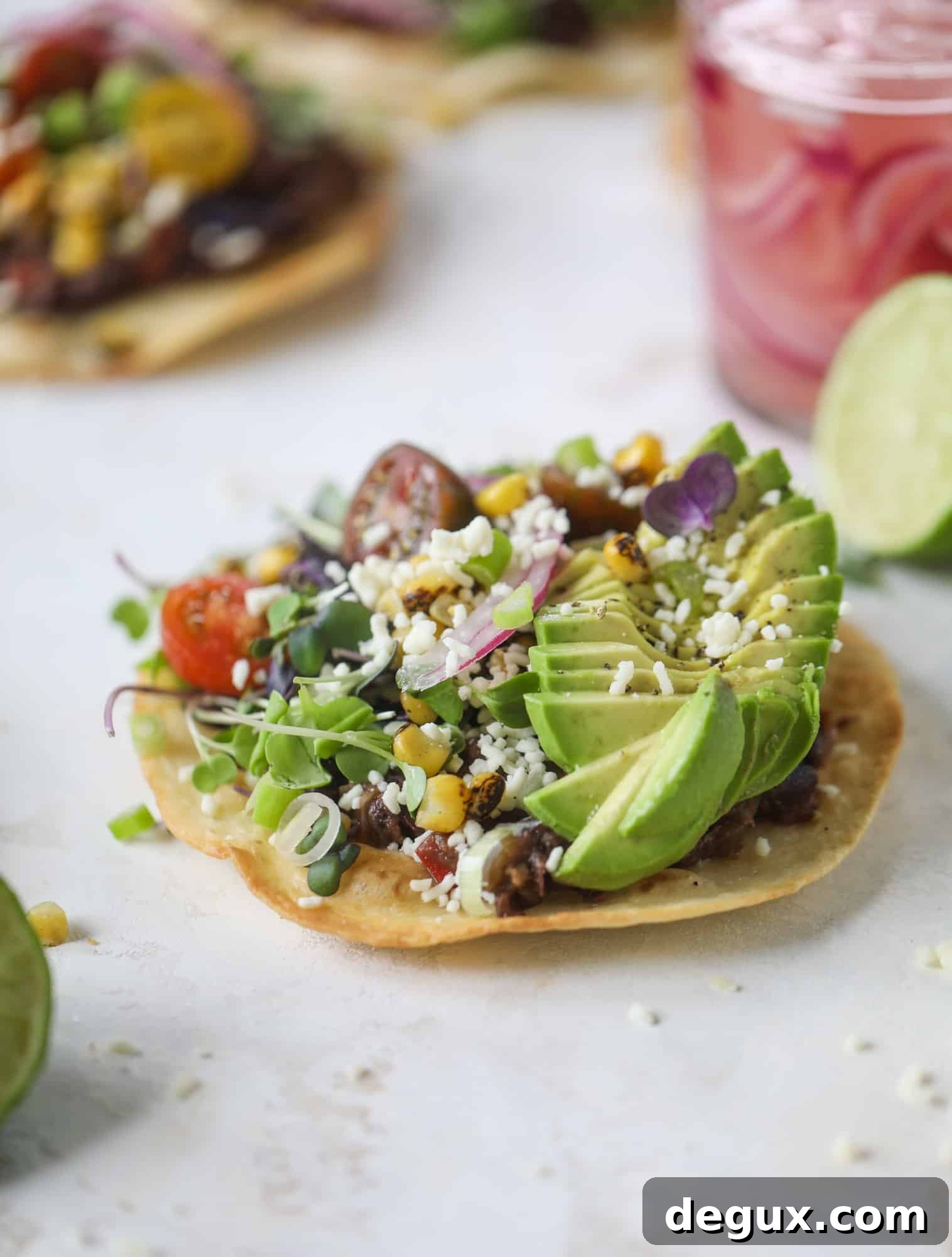 These saucy black bean tostadas are super flavorful and easy for a weeknight meal. Crunchy tortillas topped with beans and tons of veggies. Delish!