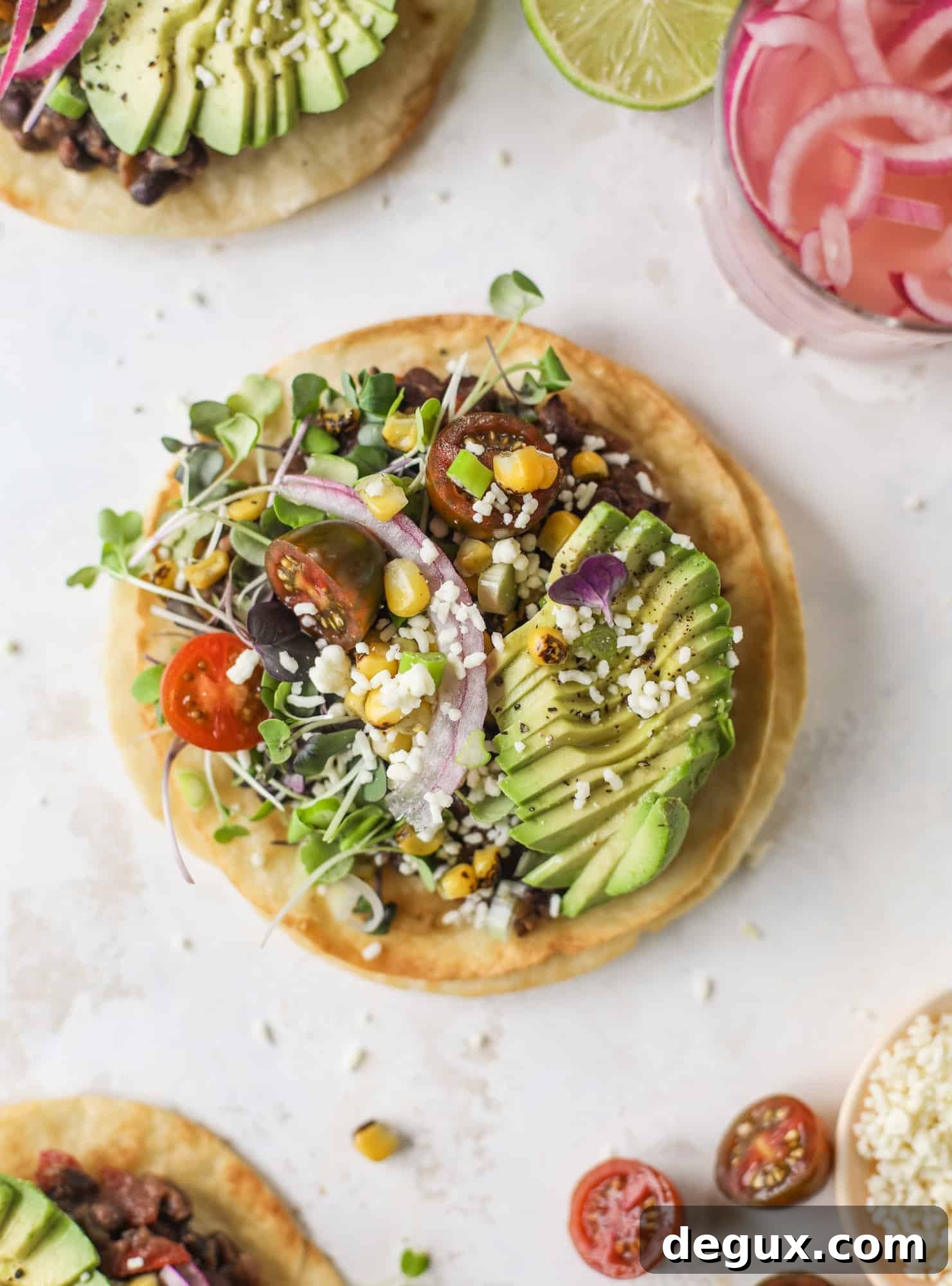 These saucy black bean tostadas are super flavorful and easy for a weeknight meal. Crunchy tortillas topped with beans and tons of veggies. Delish!