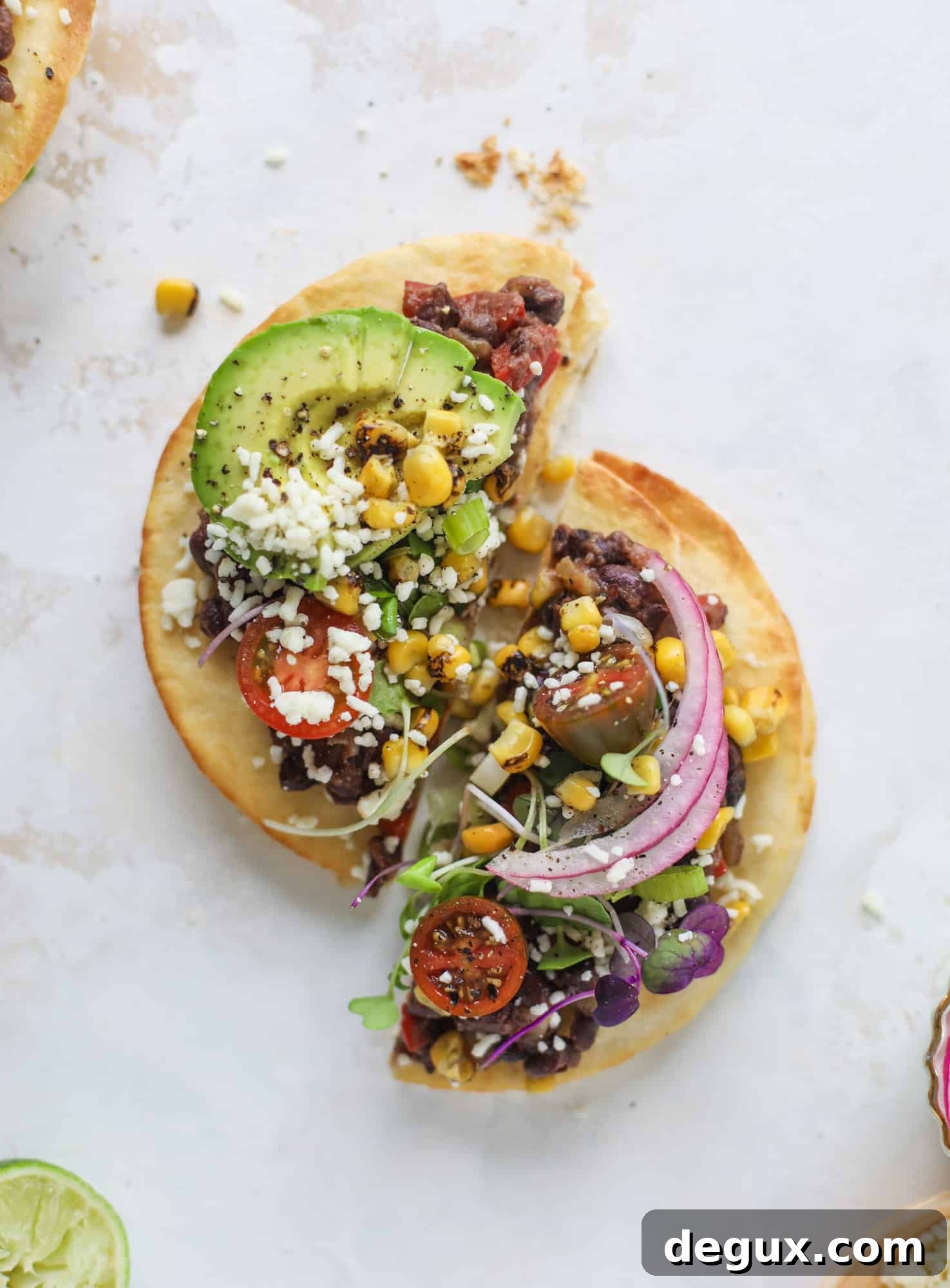 These saucy black bean tostadas are super flavorful and easy for a weeknight meal. Crunchy tortillas topped with beans and tons of veggies. Delish!