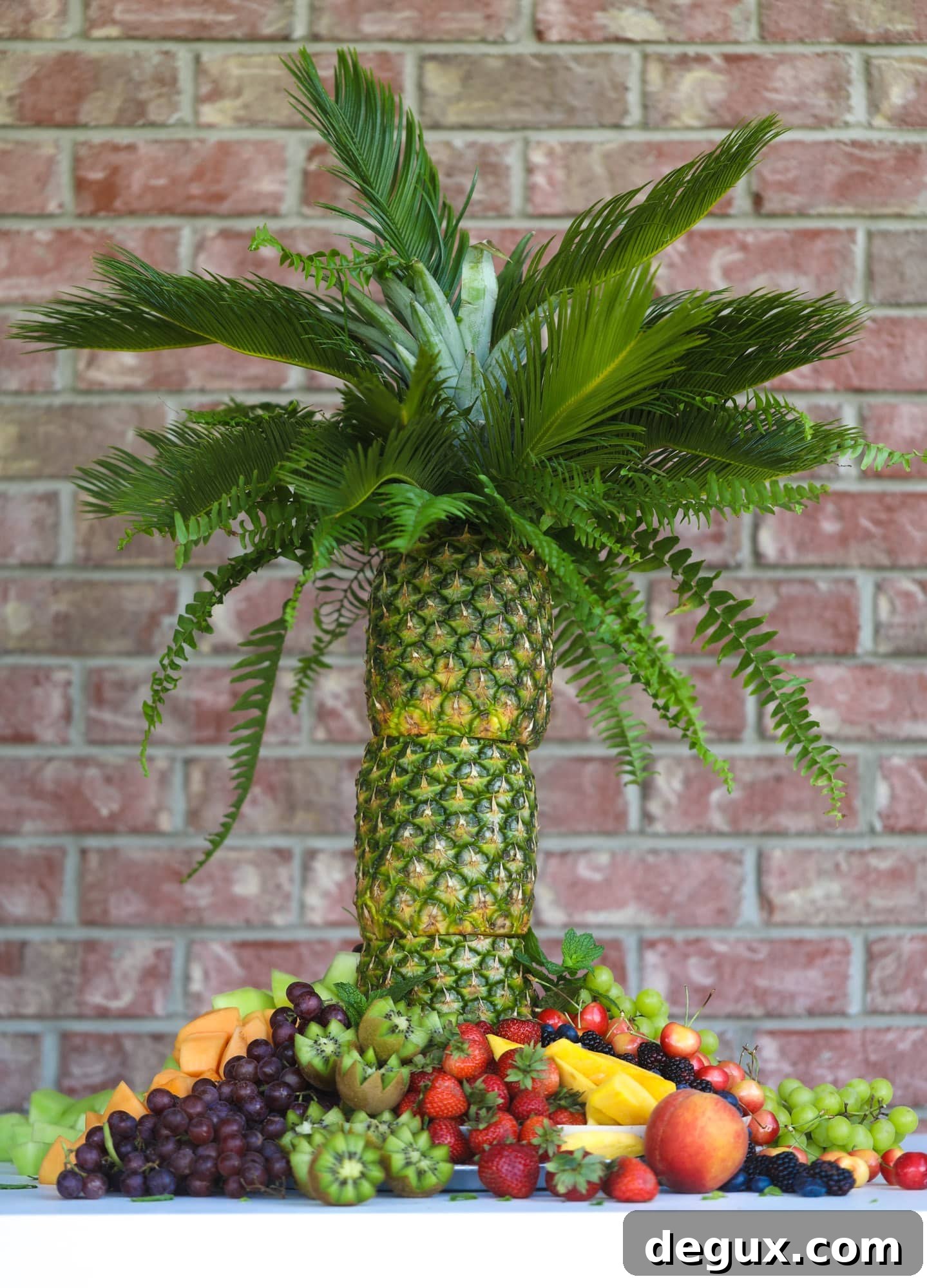 Create a Pineapple Palm Tree Fruit Tray: Step-by-Step Guide 6 This is the cutest way to display fruit! A pineapple palm tree fruit tray will be the star of the show at your next summer BBQ or party!