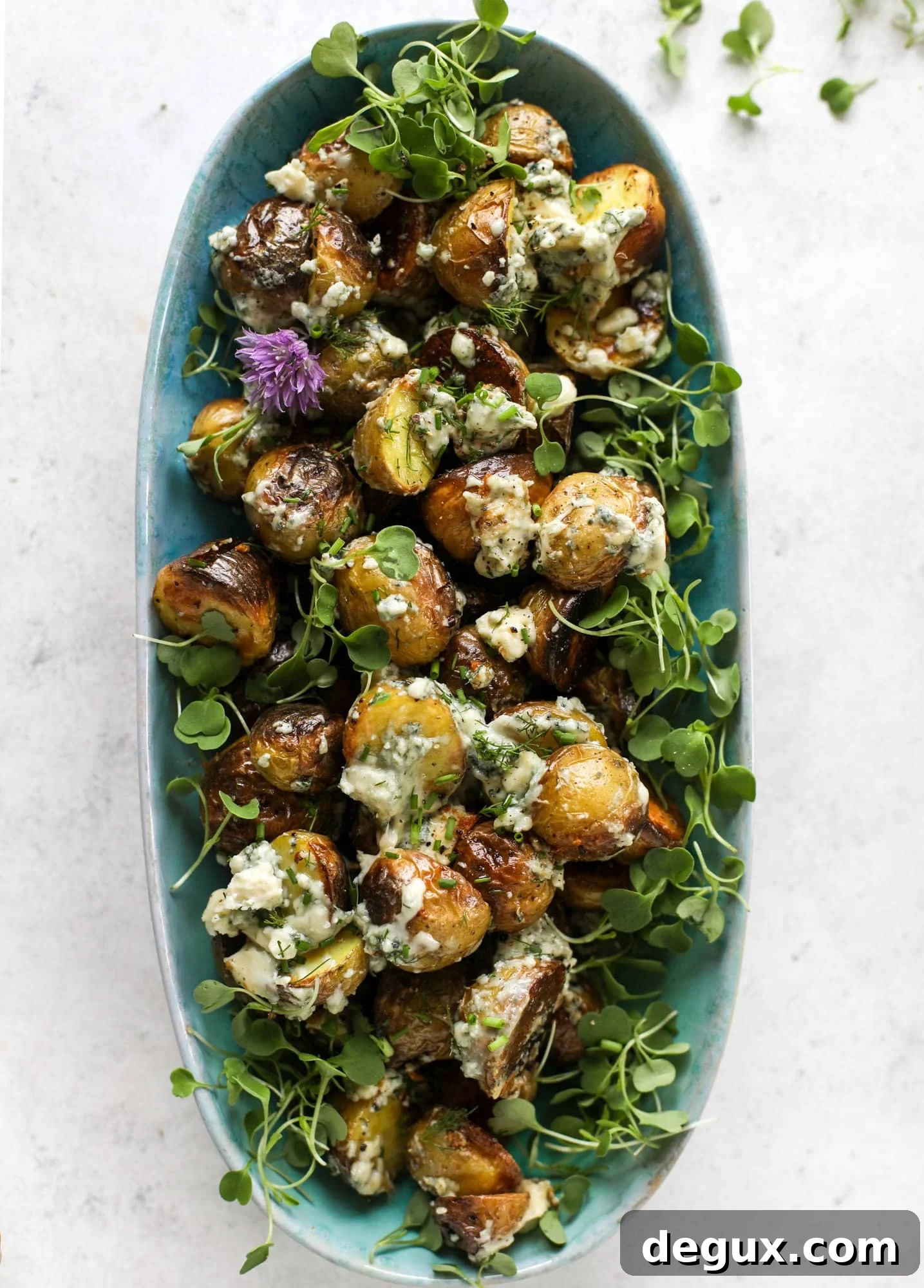 These grilled gorgonzola potatoes are loaded with flavor! Crispy, crunchy grilled baby golds topped with creamy blue cheese and fresh herbs.