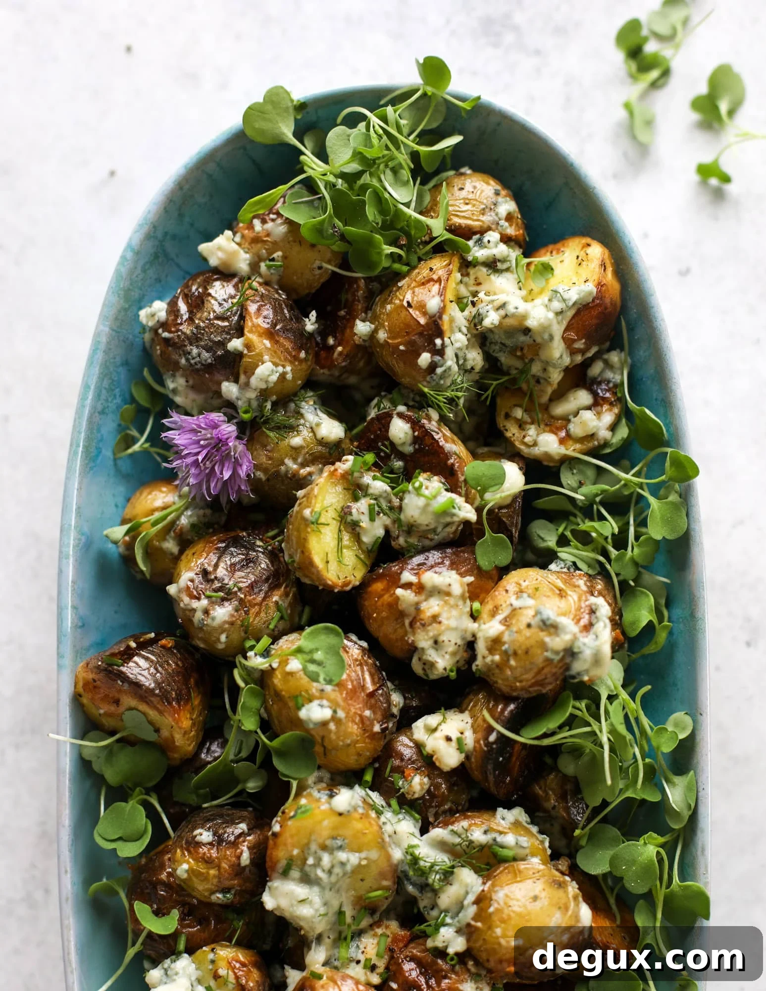 These grilled gorgonzola potatoes are loaded with flavor! Crispy, crunchy grilled baby golds topped with creamy blue cheese and fresh herbs.