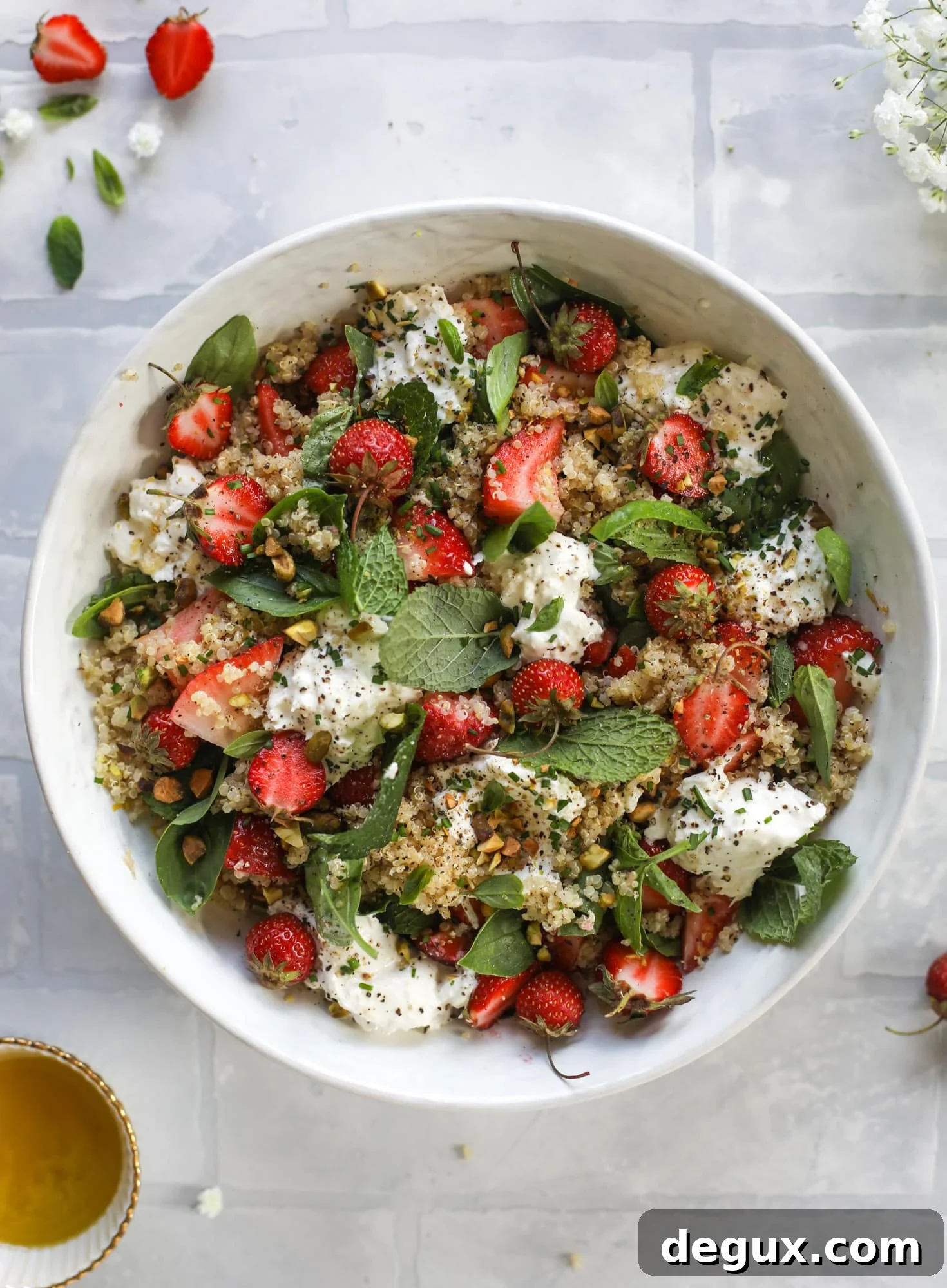 This strawberry quinoa salad is loaded with fresh herbs, burrata cheese and chopped pistachios. Topped with a lemon dressing, it's heavenly!