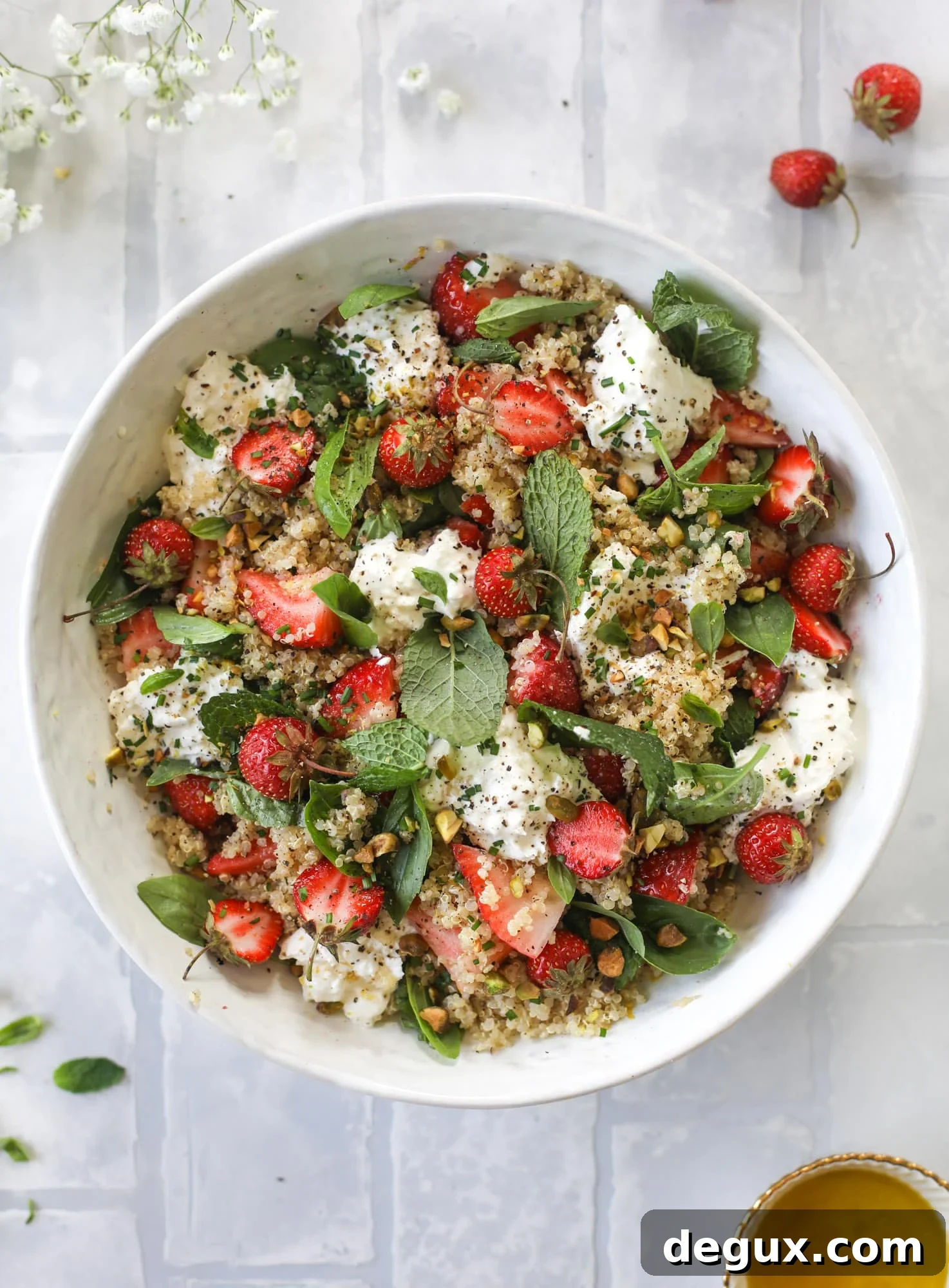 This strawberry quinoa salad is loaded with fresh herbs, burrata cheese and chopped pistachios. Topped with a lemon dressing, it's heavenly!