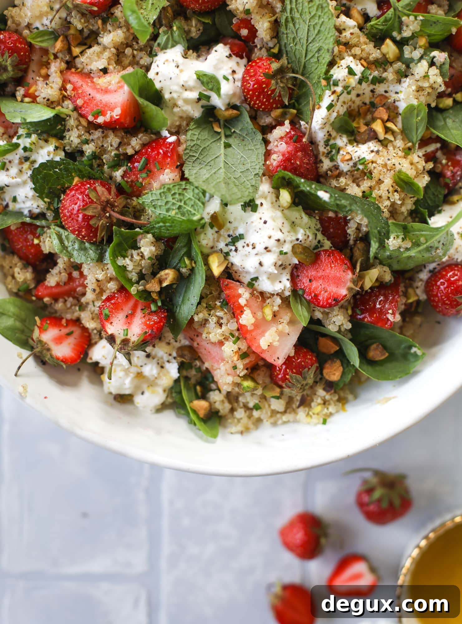 This strawberry quinoa salad is loaded with fresh herbs, burrata cheese and chopped pistachios. Topped with a lemon dressing, it's heavenly!