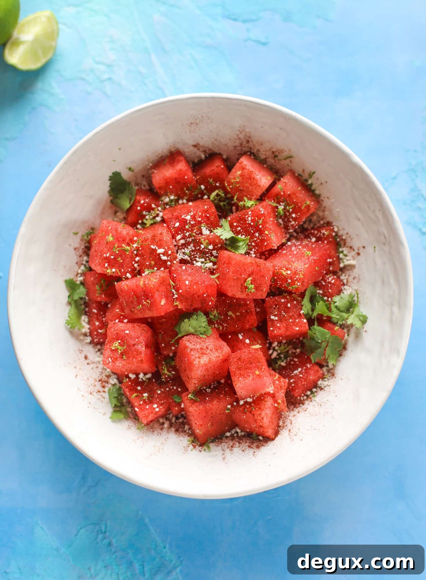 This chili lime watermelon is the perfect summer snack! It's savory and sweet with crumbled cotija cheese and lots of lime. Delish!