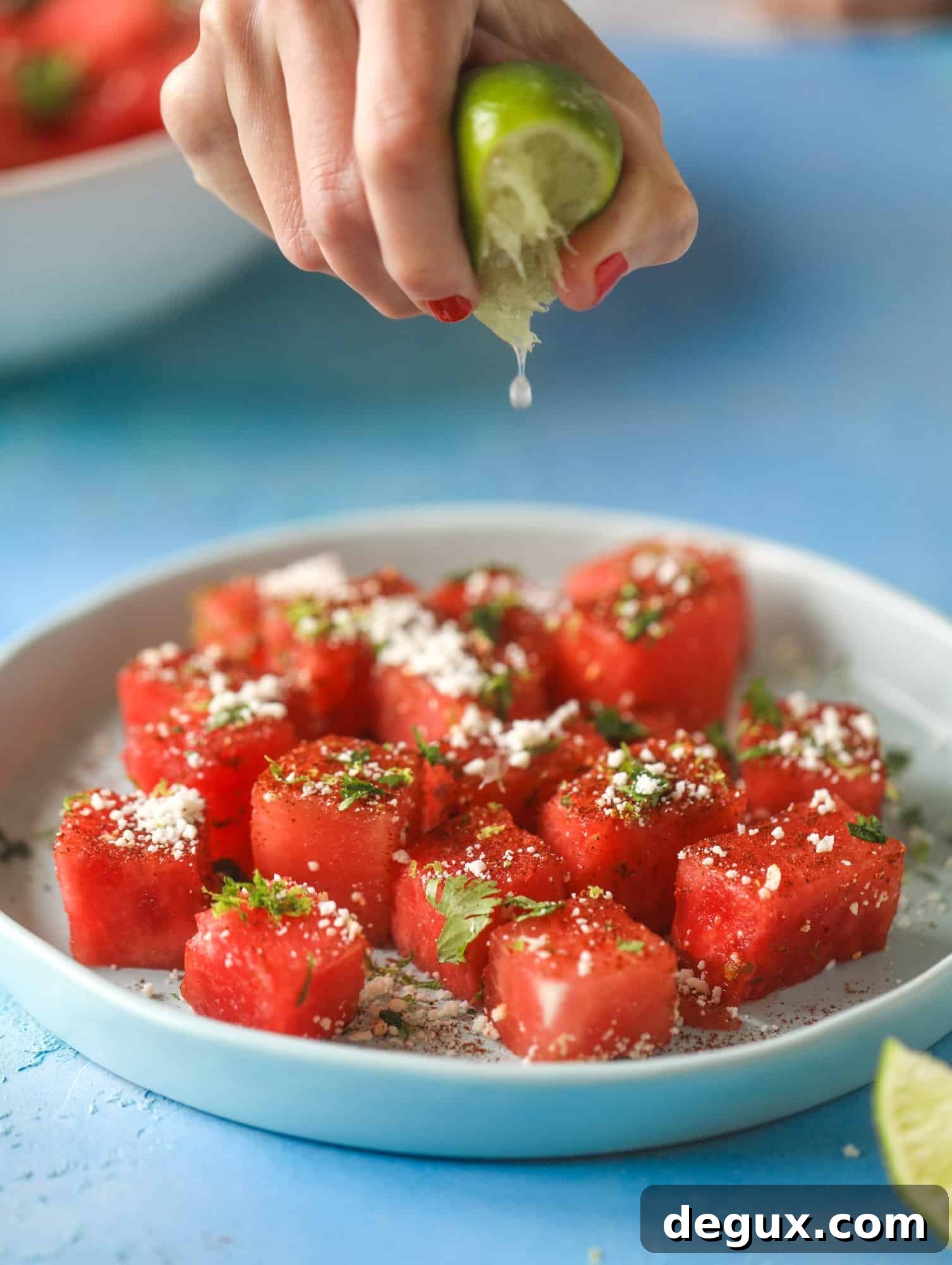 This chili lime watermelon is the perfect summer snack! It's savory and sweet with crumbled cotija cheese and lots of lime. Delish!