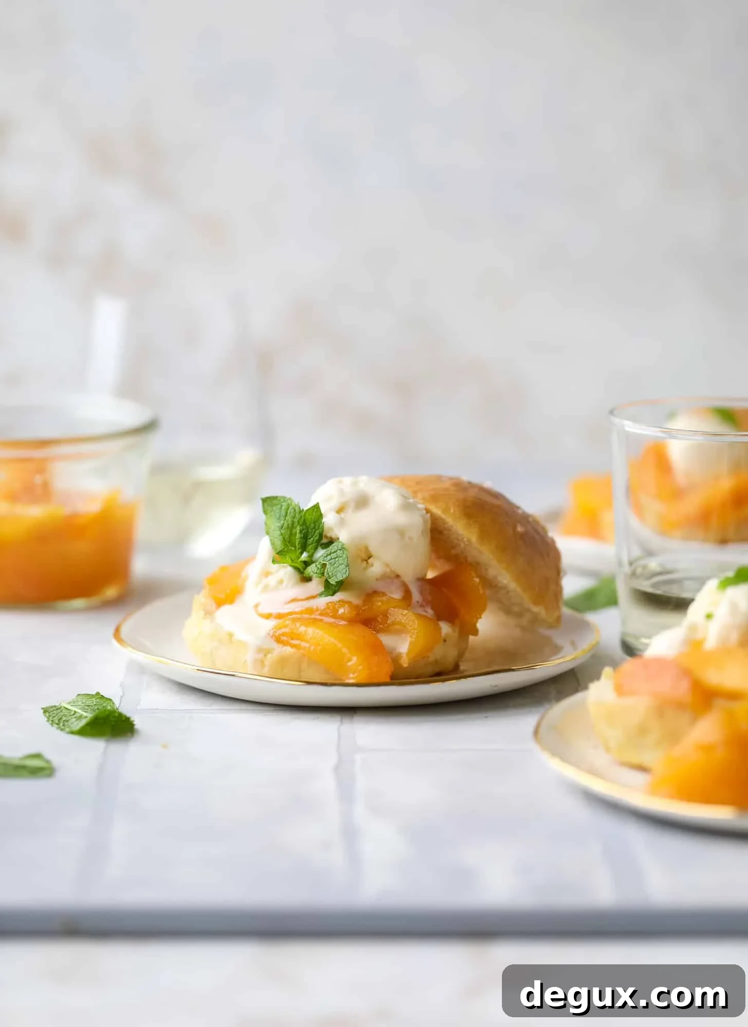 Prosecco peach shortcakes are out of these world! Prosecco poached peaches with vanilla ice cream on homemade salted brioche buns. To die for.
