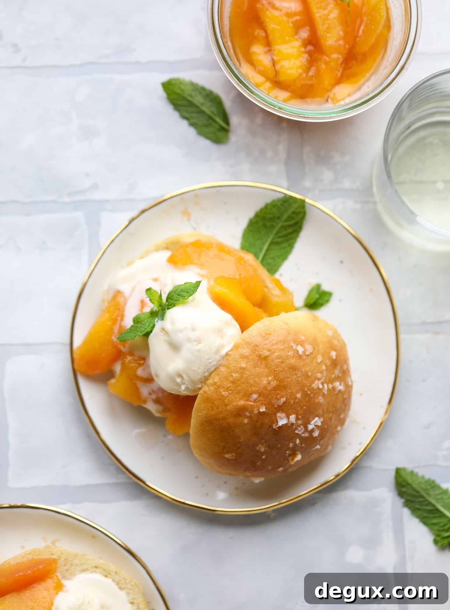 Prosecco peach shortcakes are out of these world! Prosecco poached peaches with vanilla ice cream on homemade salted brioche buns. To die for.