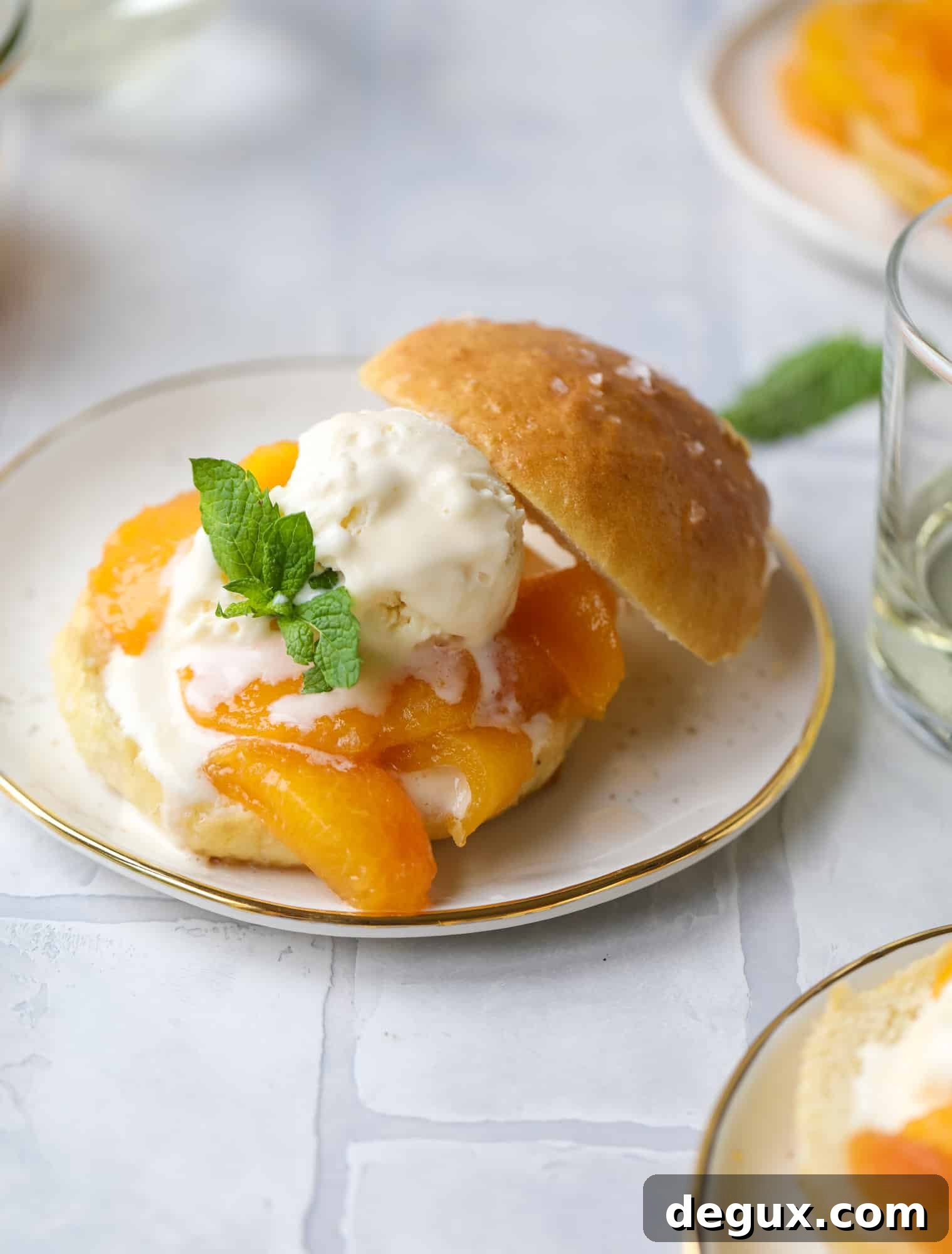 Prosecco peach shortcakes are out of these world! Prosecco poached peaches with vanilla ice cream on homemade salted brioche buns. To die for.