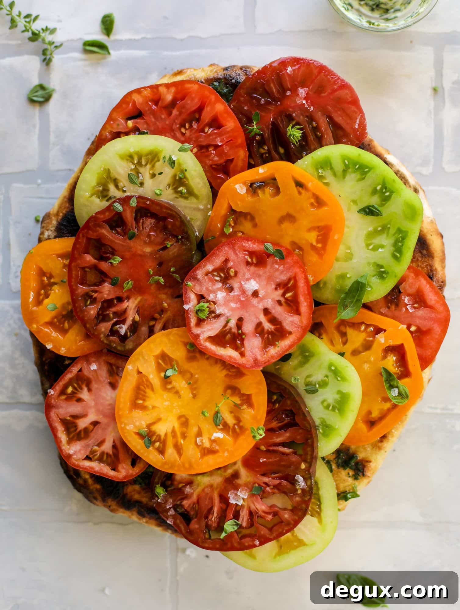 Grilled Garlic-Herb Butter Pizza with Heirloom Tomatoes 7 This heirloom tomato pizza starts with a grilled garlic herb butter crust! Melty herb butter and sliced fresh tomatoes top it off for a delicious bite!