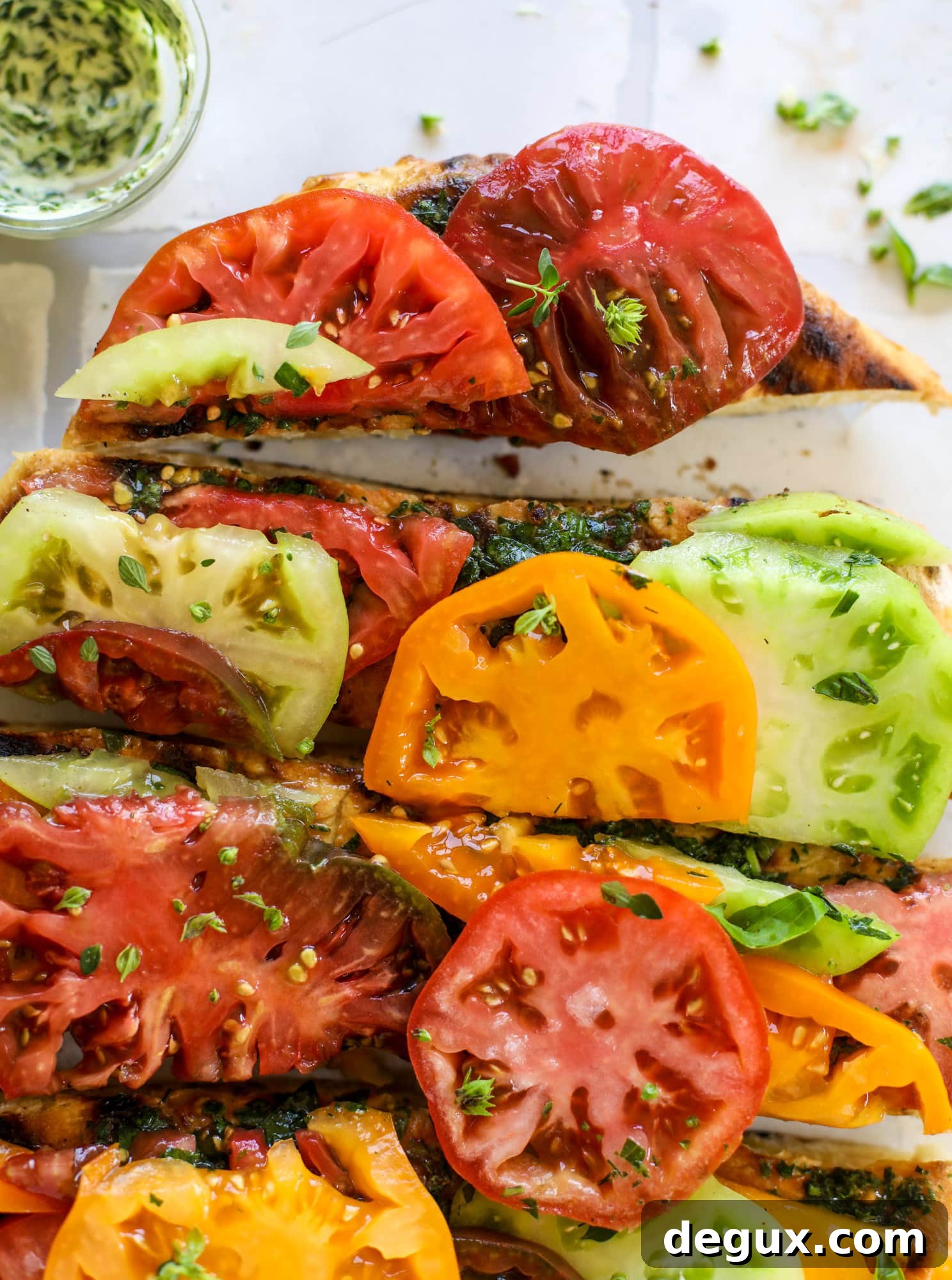 Grilled Garlic-Herb Butter Pizza with Heirloom Tomatoes 8 This heirloom tomato pizza starts with a grilled garlic herb butter crust! Melty herb butter and sliced fresh tomatoes top it off for a delicious bite!