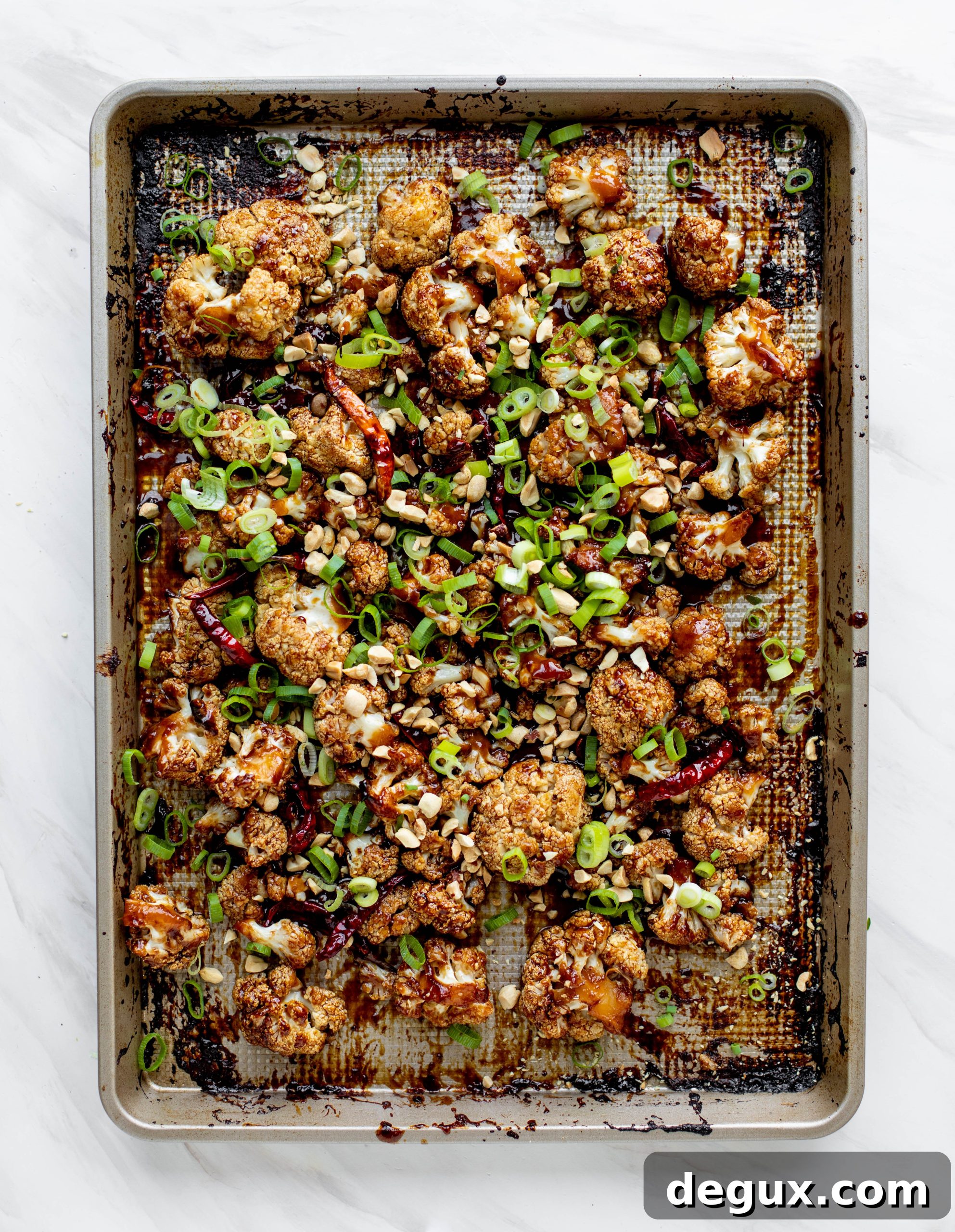This kung pao cauliflower recipe is roasted on one sheet pan and covered in a delicious sauce! Serve alongside jasmine rice for the best dinner ever.