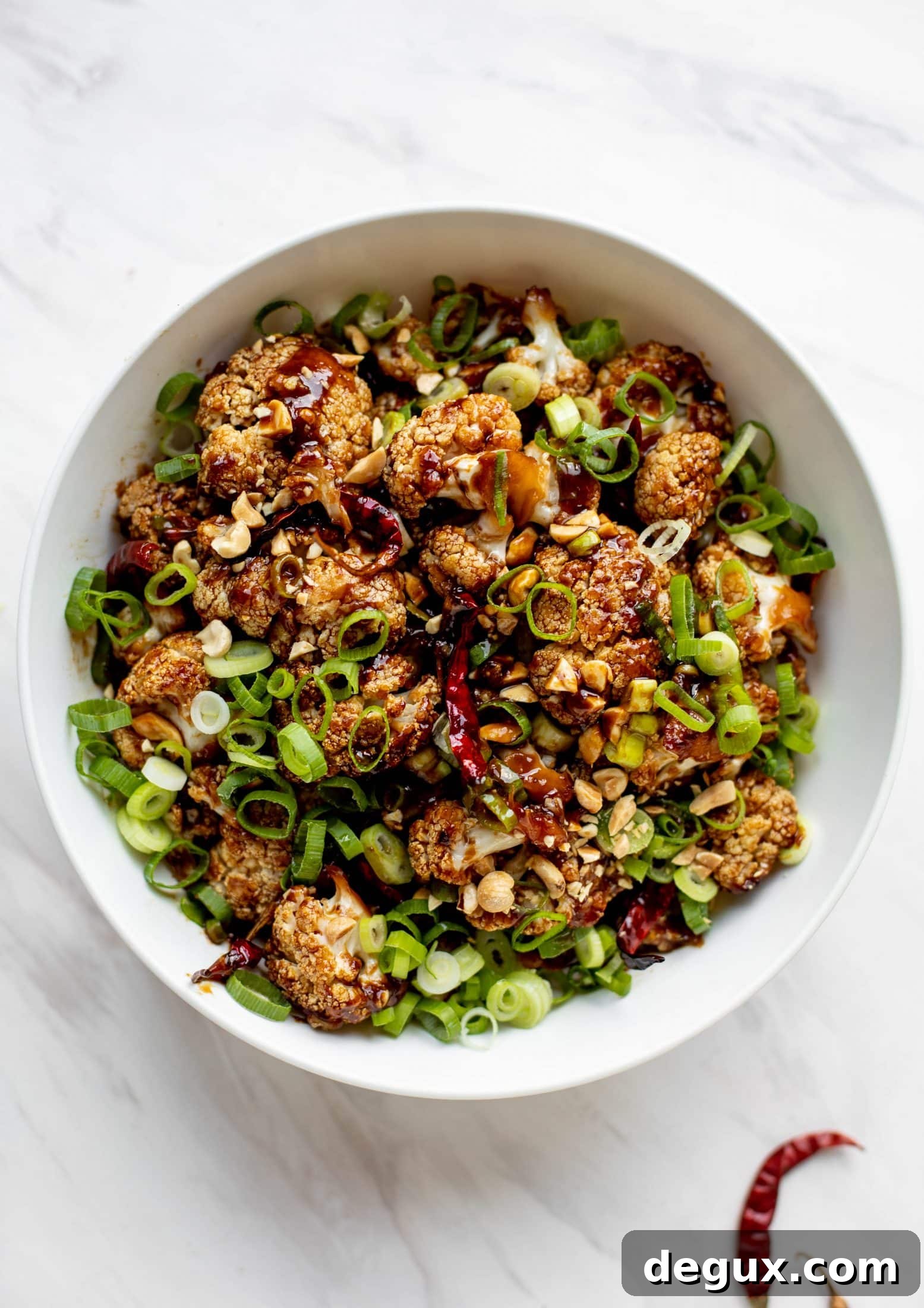 This kung pao cauliflower recipe is roasted on one sheet pan and covered in a delicious sauce! Serve alongside jasmine rice for the best dinner ever.