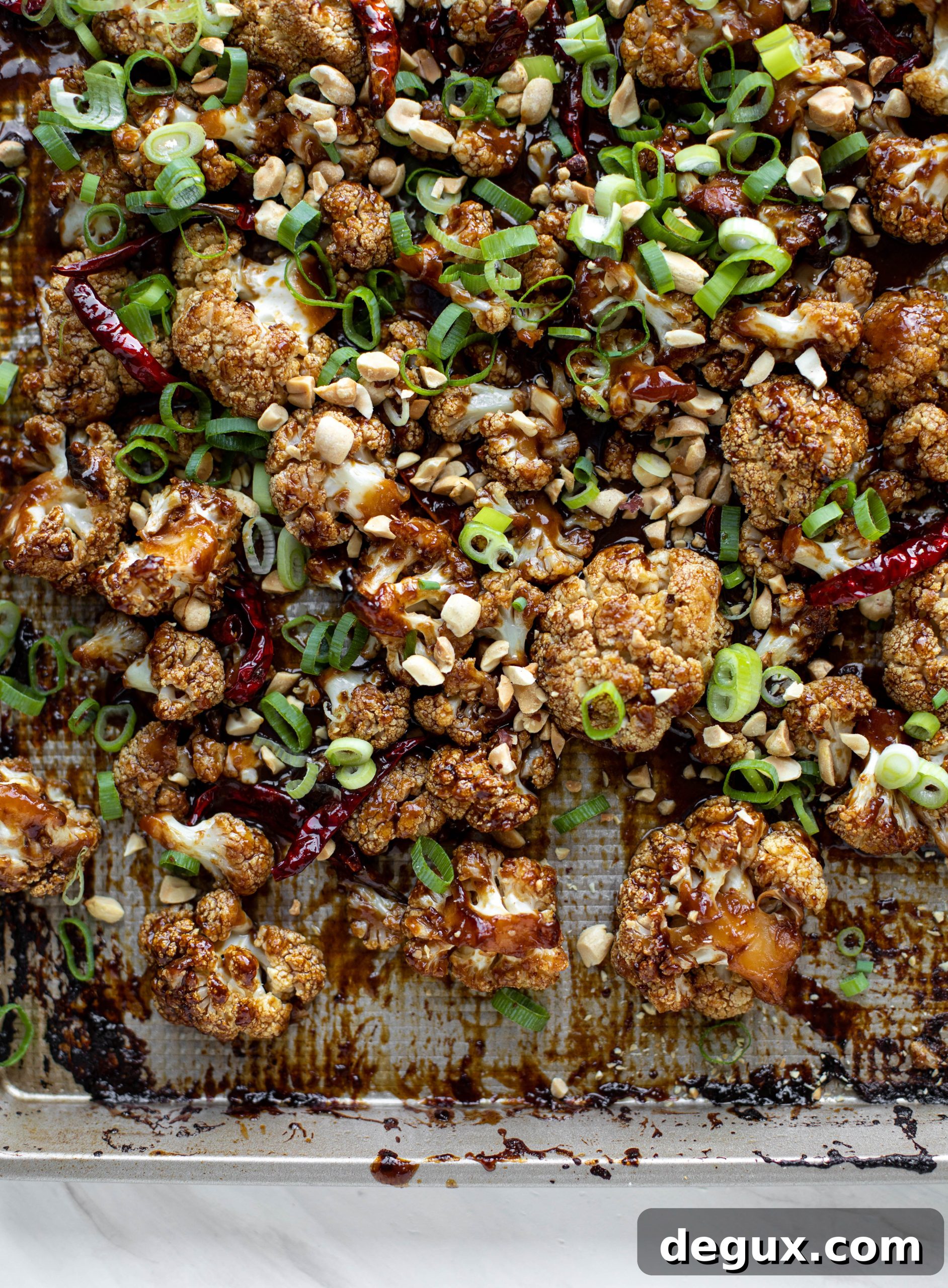This kung pao cauliflower recipe is roasted on one sheet pan and covered in a delicious sauce! Serve alongside jasmine rice for the best dinner ever.
