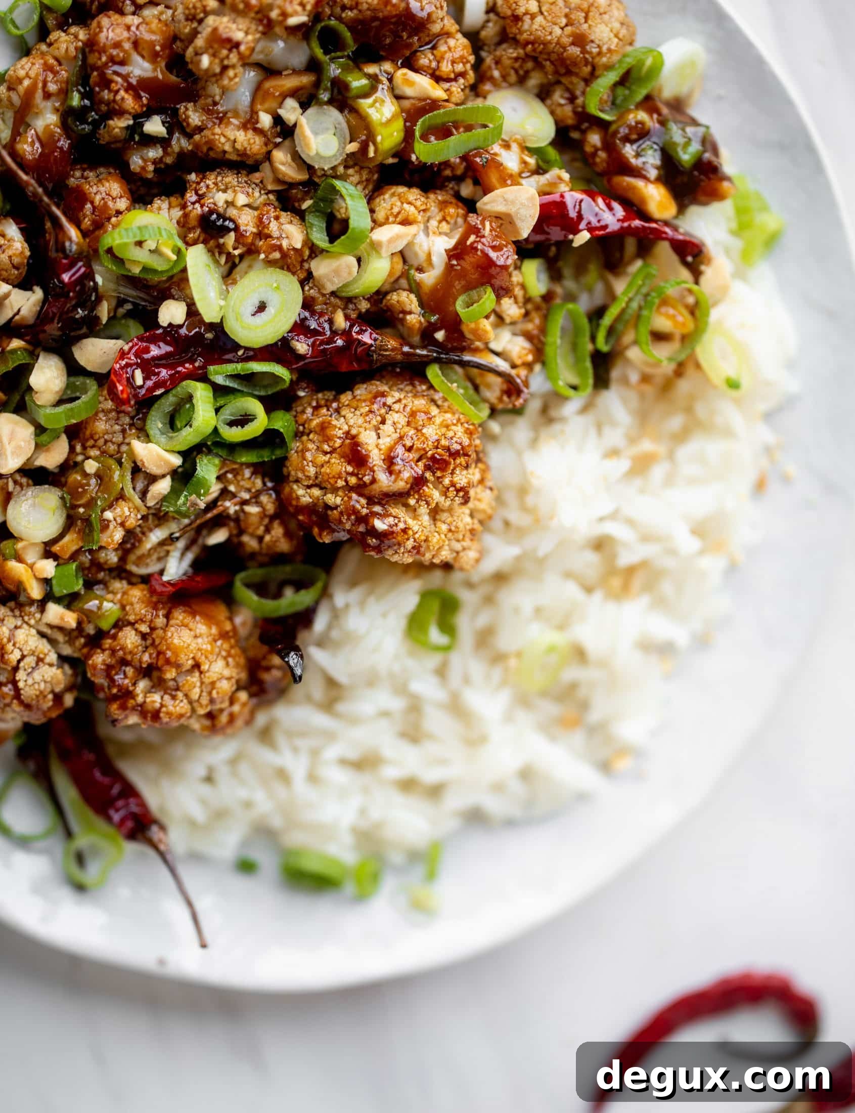 This kung pao cauliflower recipe is roasted on one sheet pan and covered in a delicious sauce! Serve alongside jasmine rice for the best dinner ever.