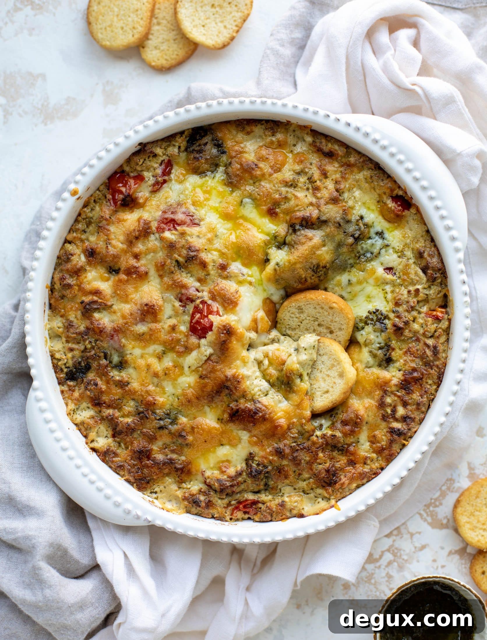 This cheesy pesto chicken dip is a great way to use up your end-of-summer herbs! Lots of delicious smoky flavor and tons of bubbly cheese.