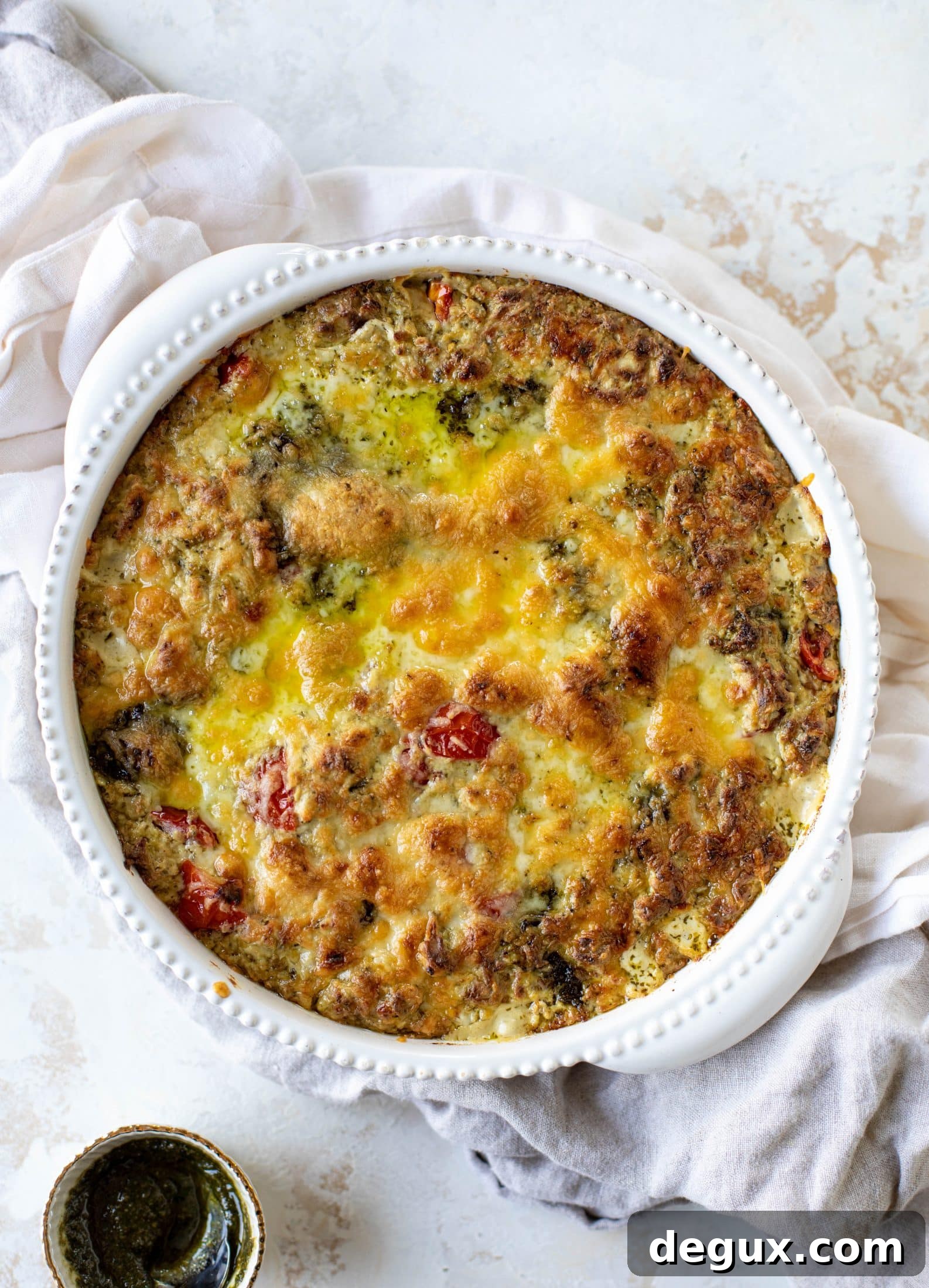 This cheesy pesto chicken dip is a great way to use up your end-of-summer herbs! Lots of delicious smoky flavor and tons of bubbly cheese.