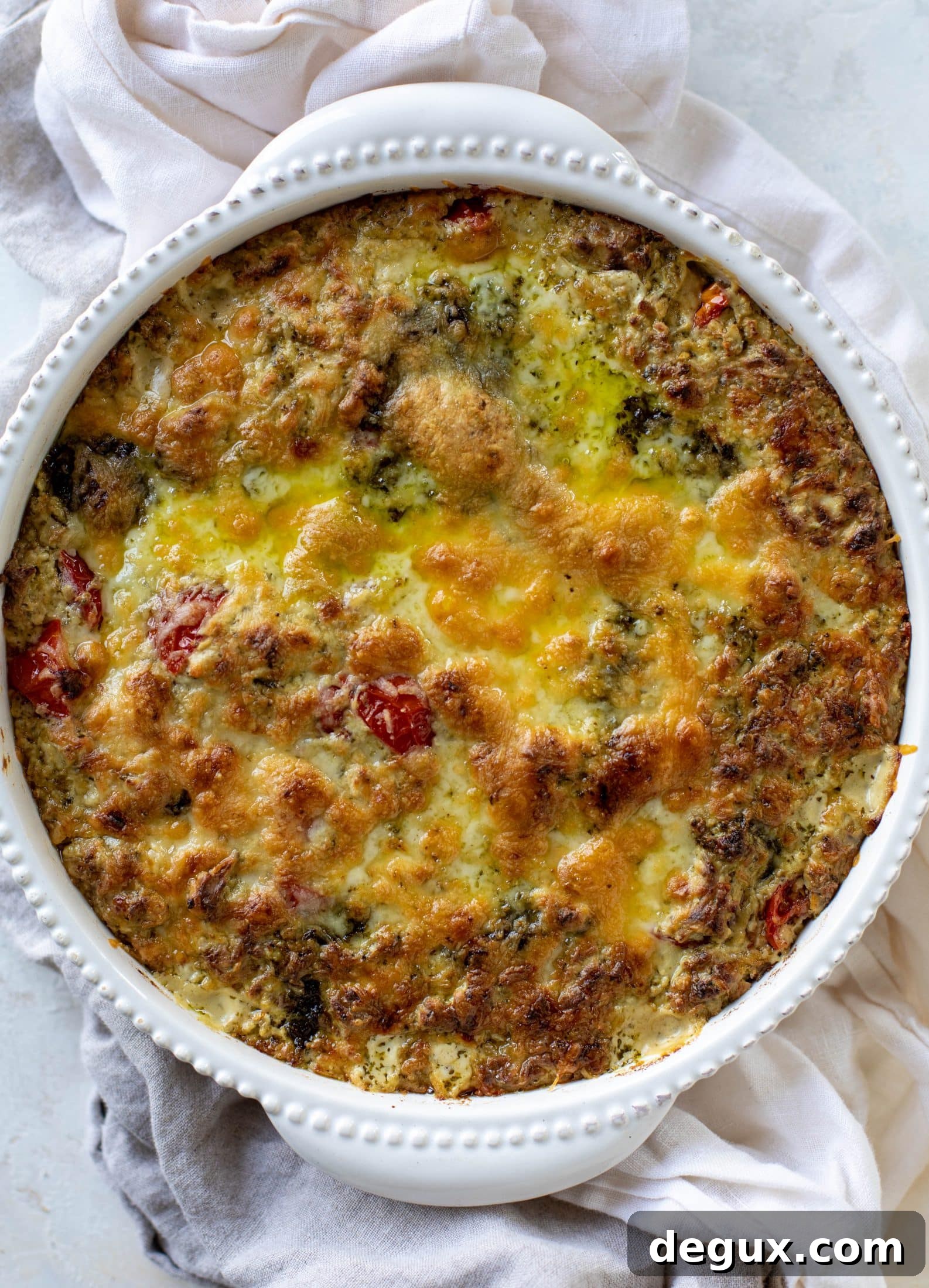 This cheesy pesto chicken dip is a great way to use up your end-of-summer herbs! Lots of delicious smoky flavor and tons of bubbly cheese.