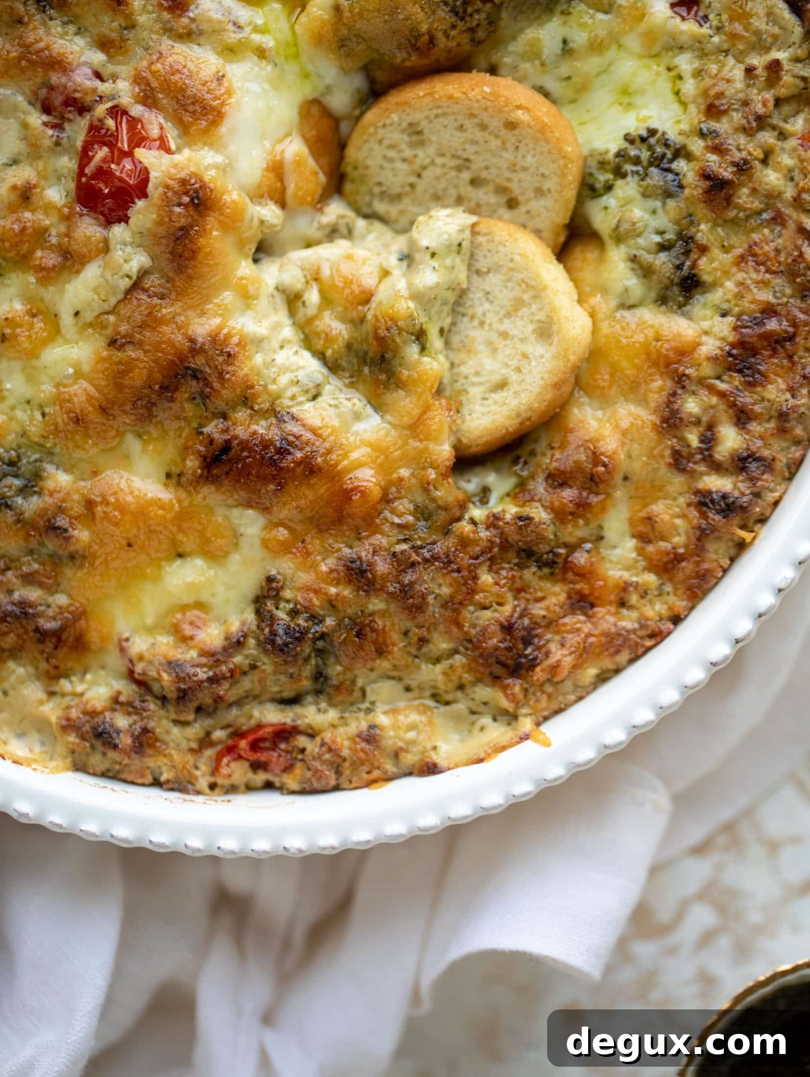 This cheesy pesto chicken dip is a great way to use up your end-of-summer herbs! Lots of delicious smoky flavor and tons of bubbly cheese.