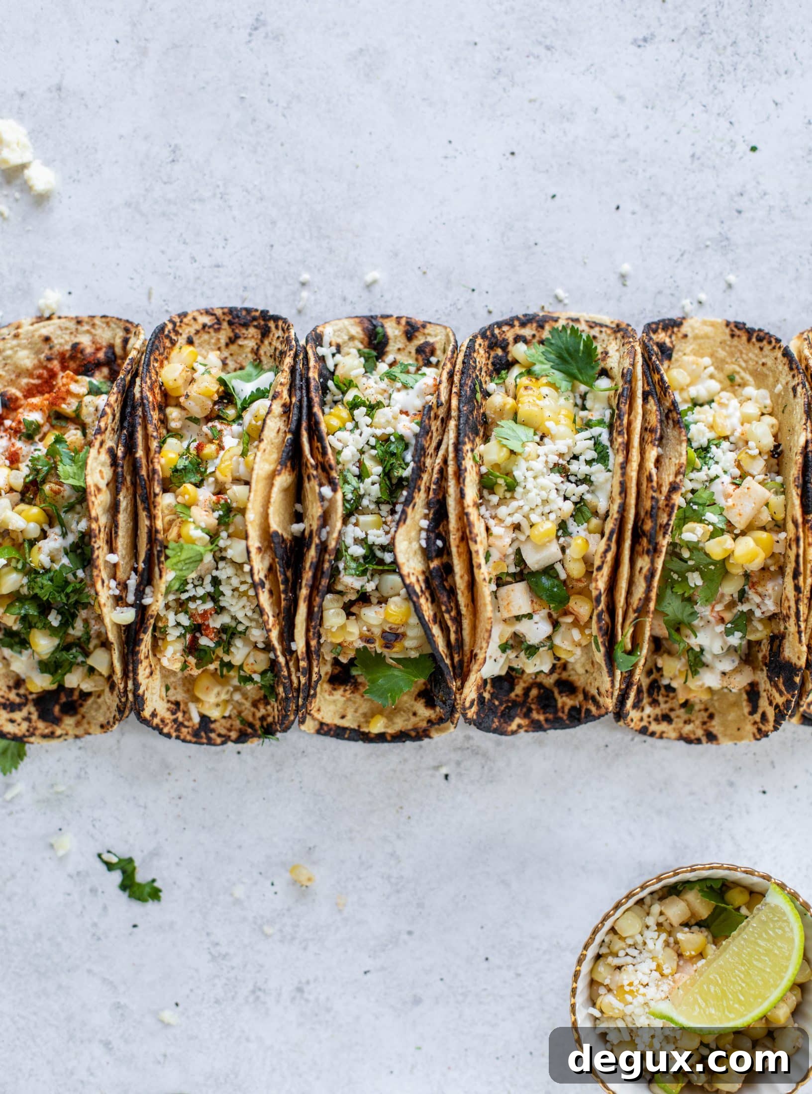 These street corn tacos are filled with a jicama corn salad and drizzled with garlic mayo. This little taco packs a major flavor punch.