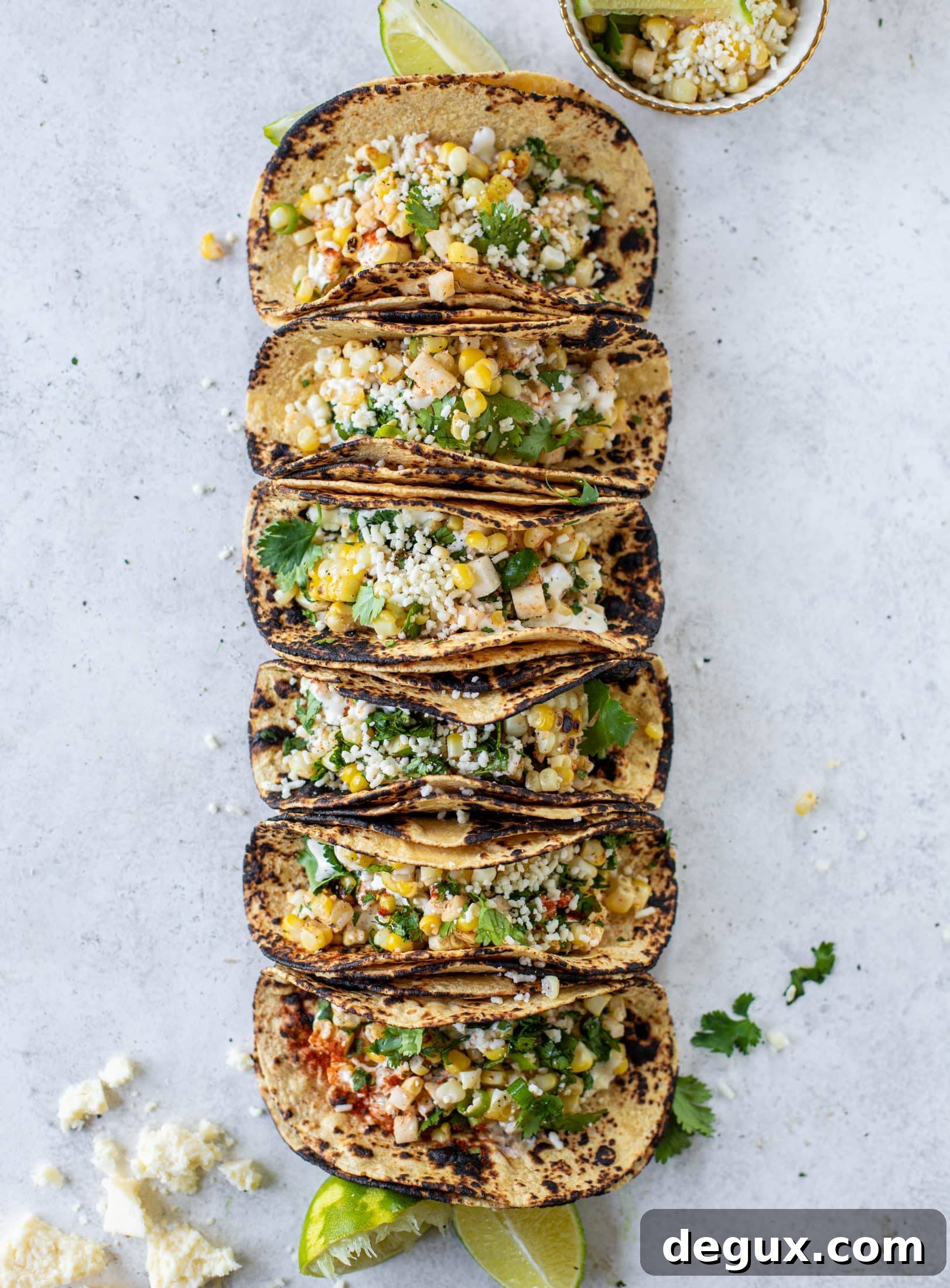These street corn tacos are filled with a jicama corn salad and drizzled with garlic mayo. This little taco packs a major flavor punch.