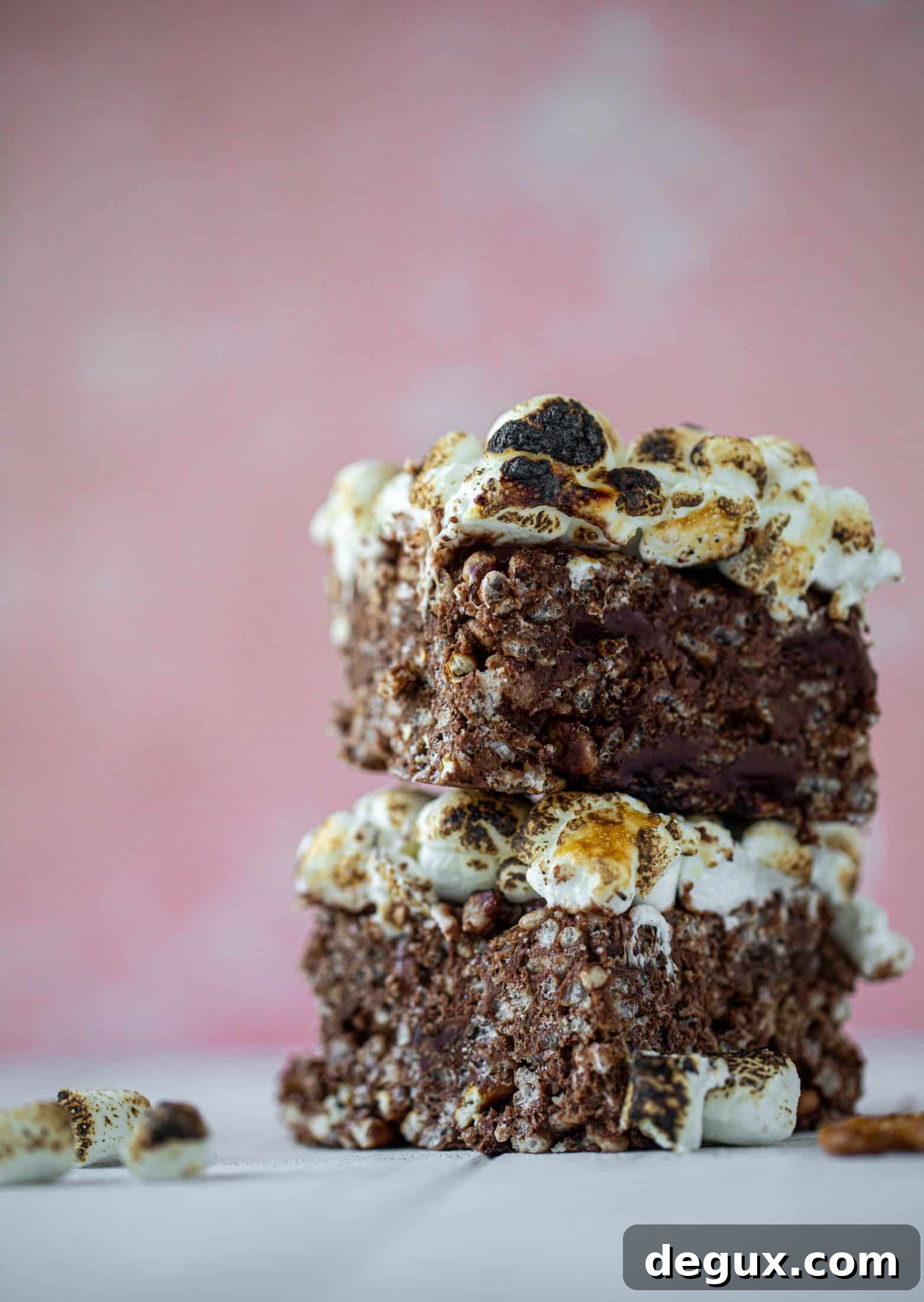 These indulgent s'mores bars are crispy and crunchy and studded with salted pretzels! Toasted marshmallow and dark chocolate make these the best treat ever!