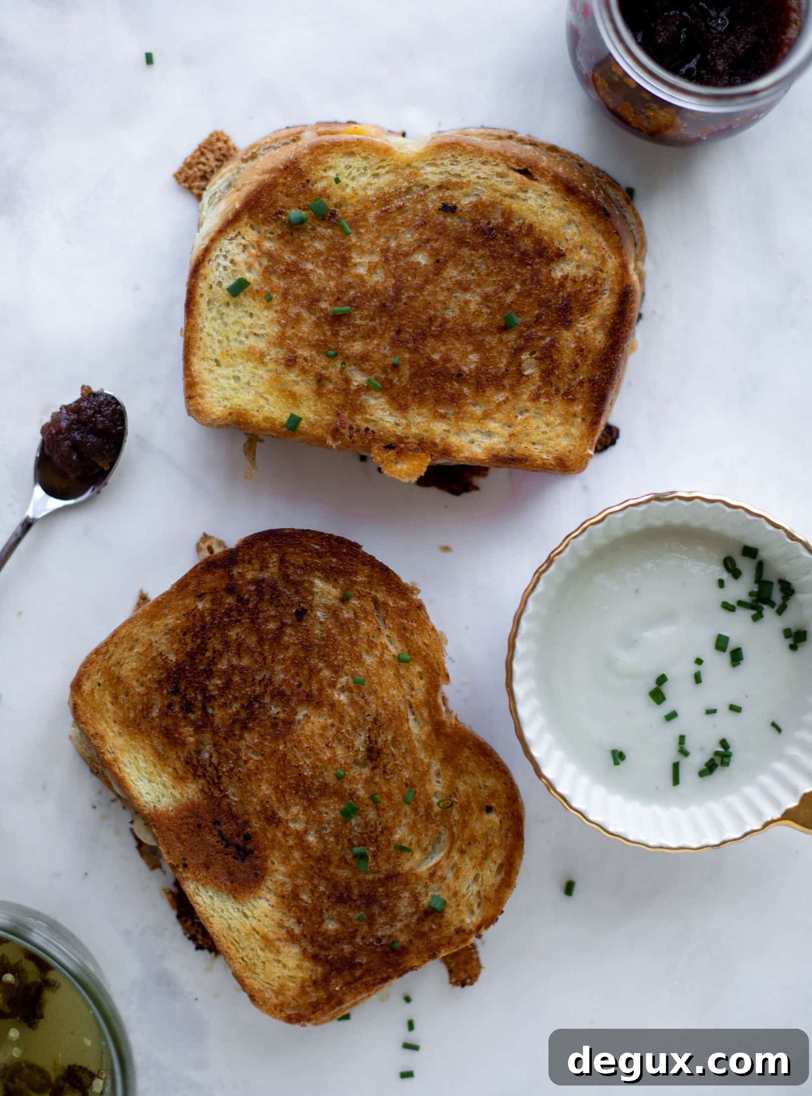 This bacon grilled cheese is filled with sharp cheddar and candied jalapeños! Served alongside a soup dipped for the ultimate comforting meal.