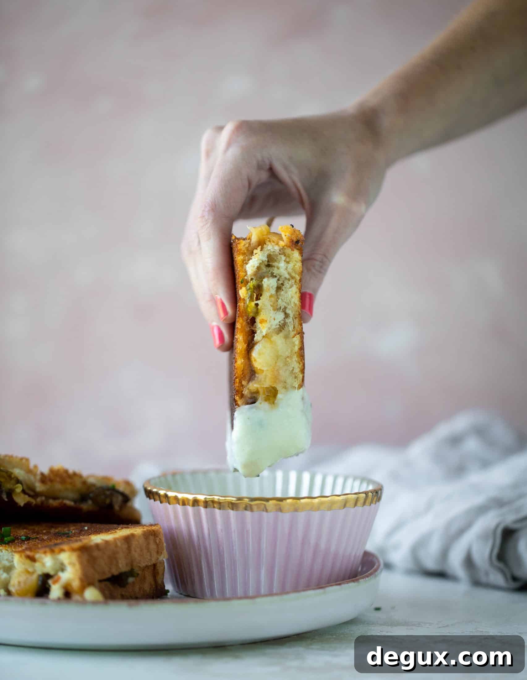 This bacon grilled cheese is filled with sharp cheddar and candied jalapeños! Served alongside a soup dipped for the ultimate comforting meal.