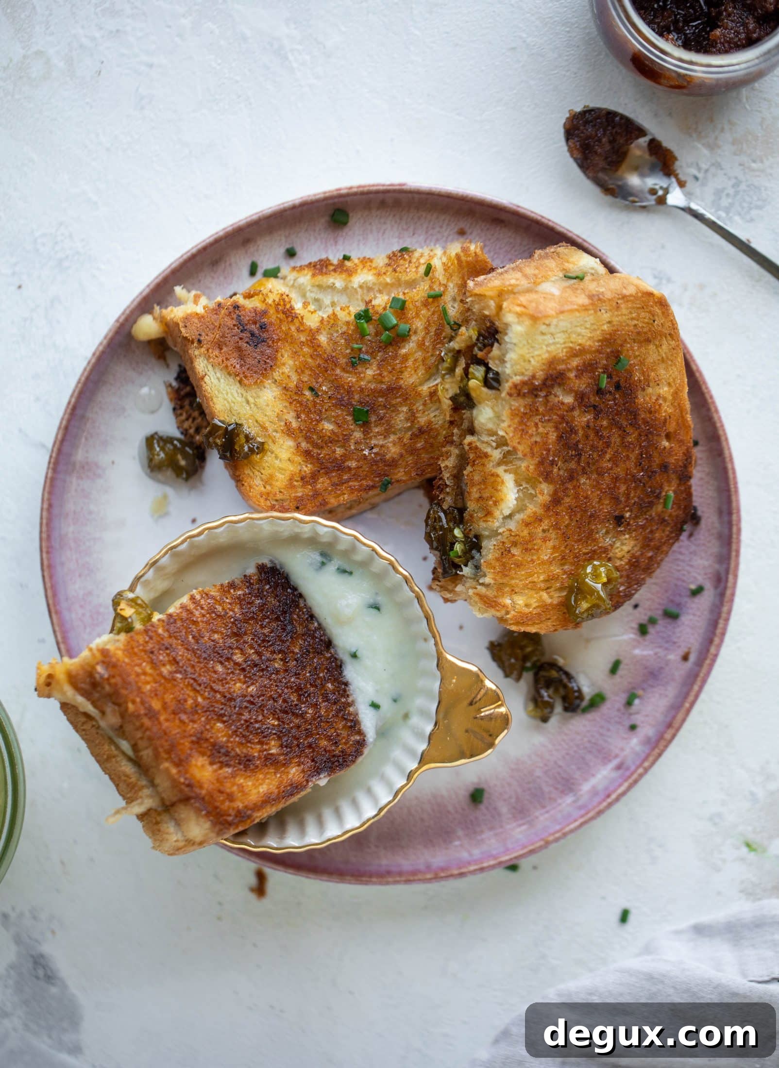 This bacon grilled cheese is filled with sharp cheddar and candied jalapeños! Served alongside a soup dipped for the ultimate comforting meal.