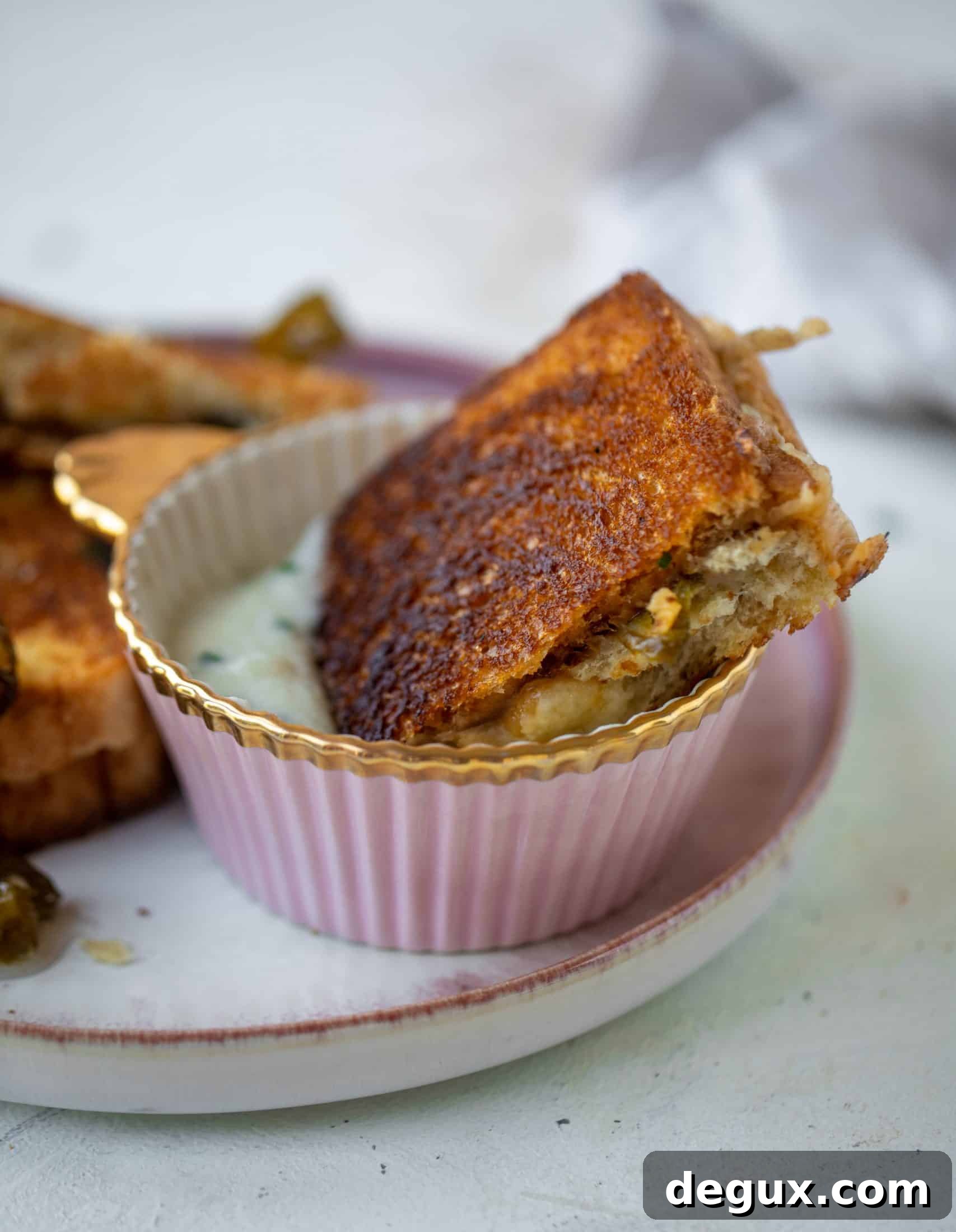 This bacon grilled cheese is filled with sharp cheddar and candied jalapeños! Served alongside a soup dipped for the ultimate comforting meal.