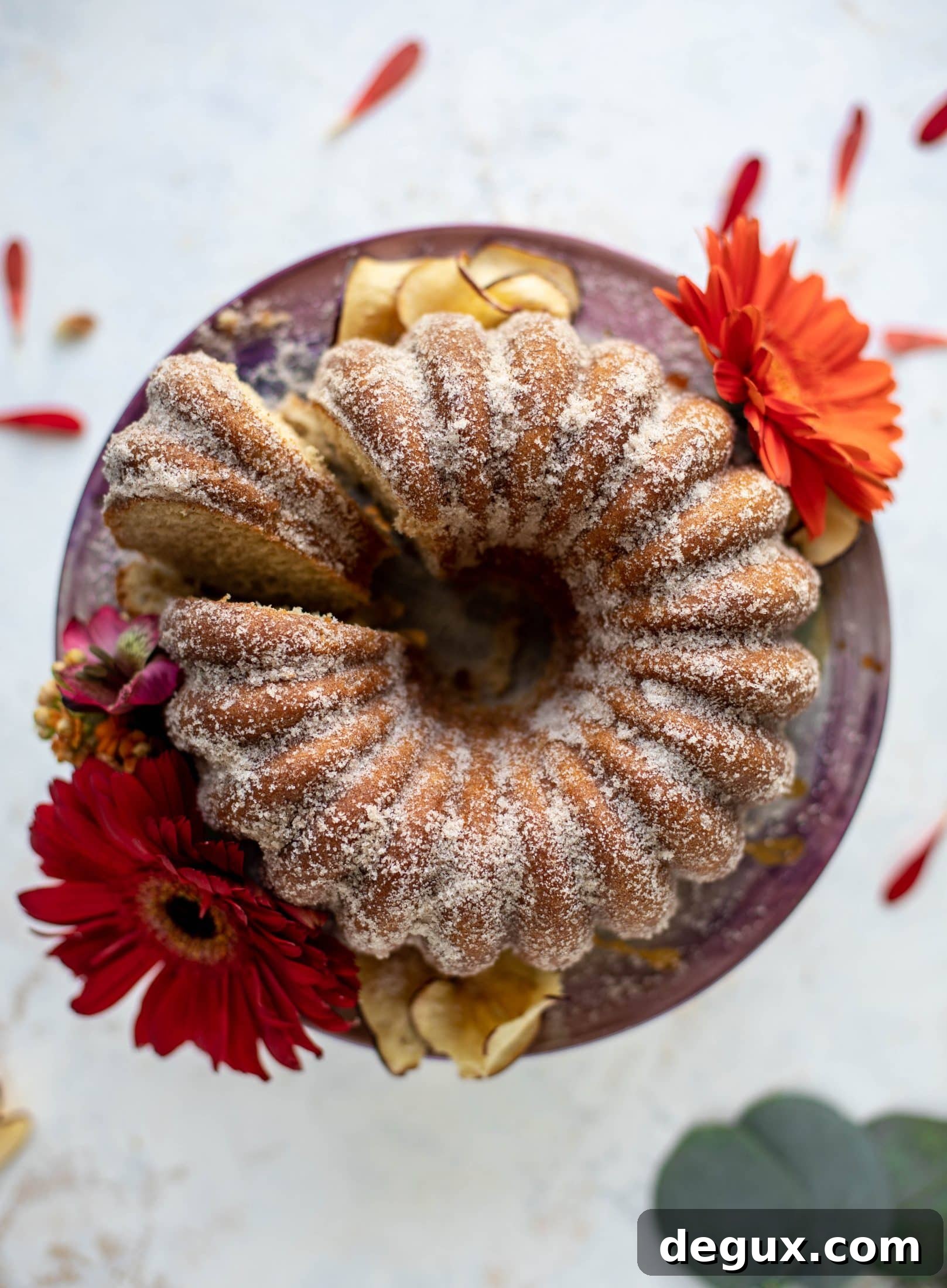 This apple cider donut cake is a huge fall crowd pleaser! Covered in cinnamon sugar and fluffy to perfection. It's incredible!