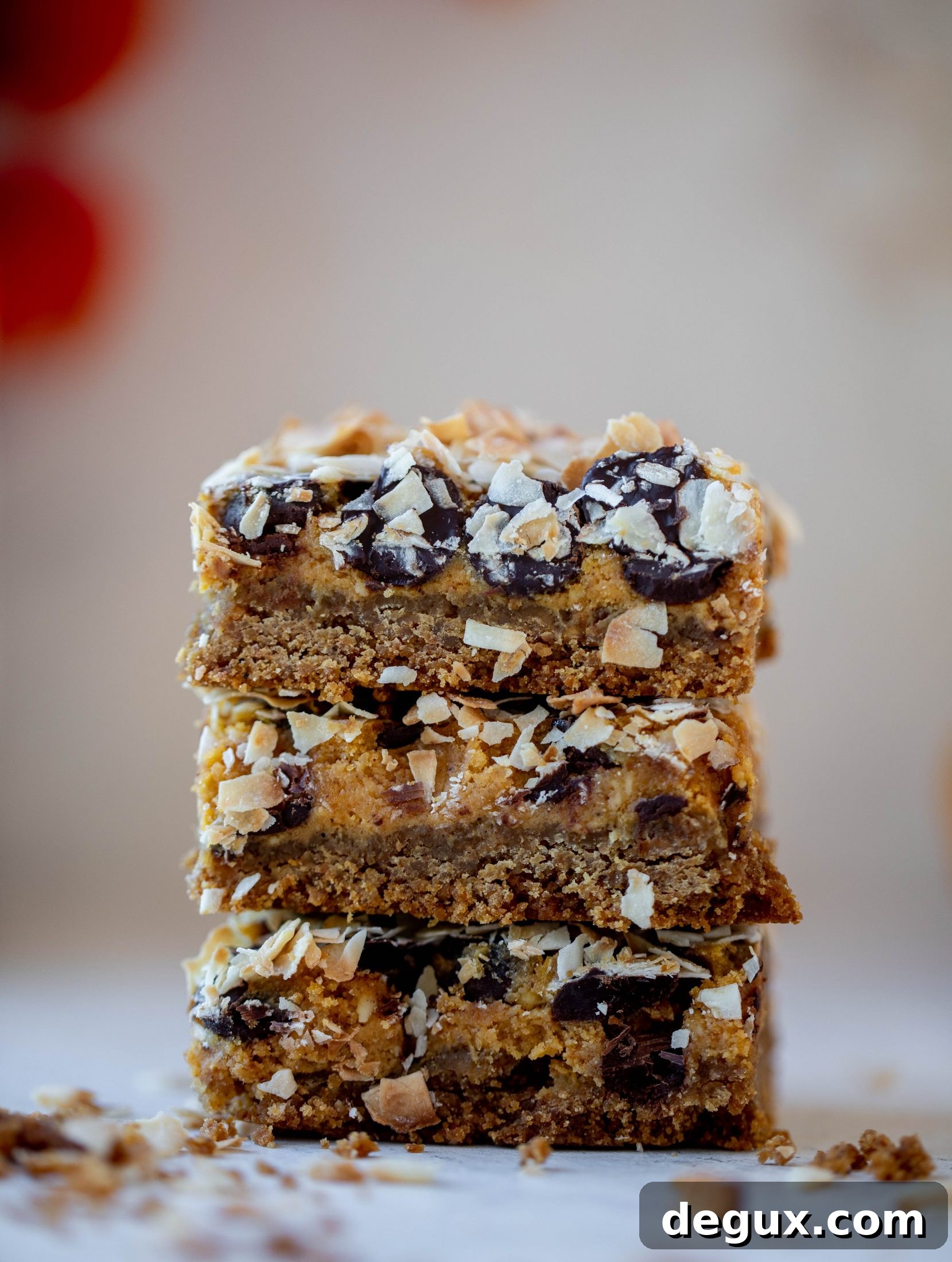 Pumpkin gooey bars are a decadent chocolate, coconut and pumpkin dessert! Crunchy graham crust, gooey pumpkin center and a crisp topping. Yum!
