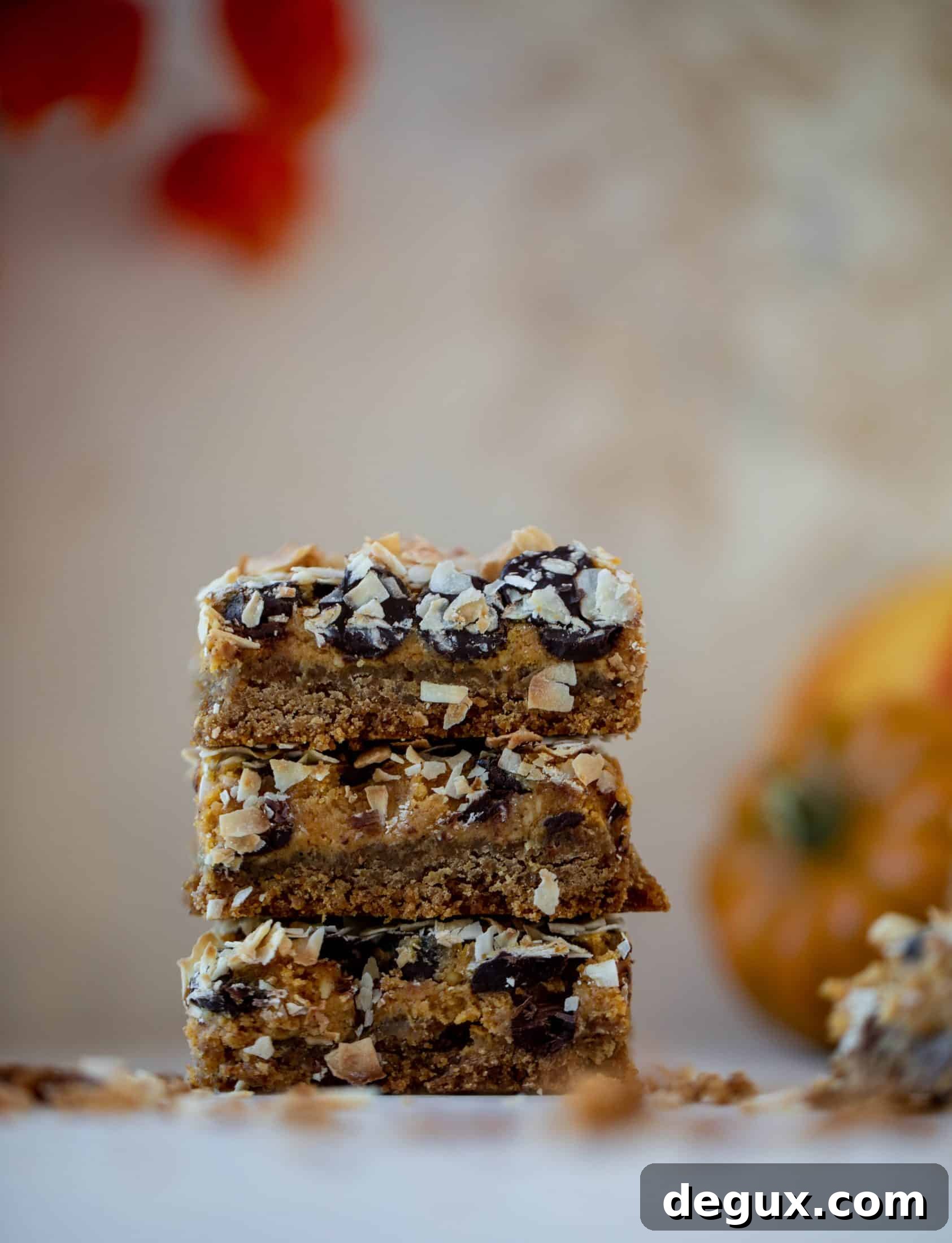 Pumpkin gooey bars are a decadent chocolate, coconut and pumpkin dessert! Crunchy graham crust, gooey pumpkin center and a crisp topping. Yum!