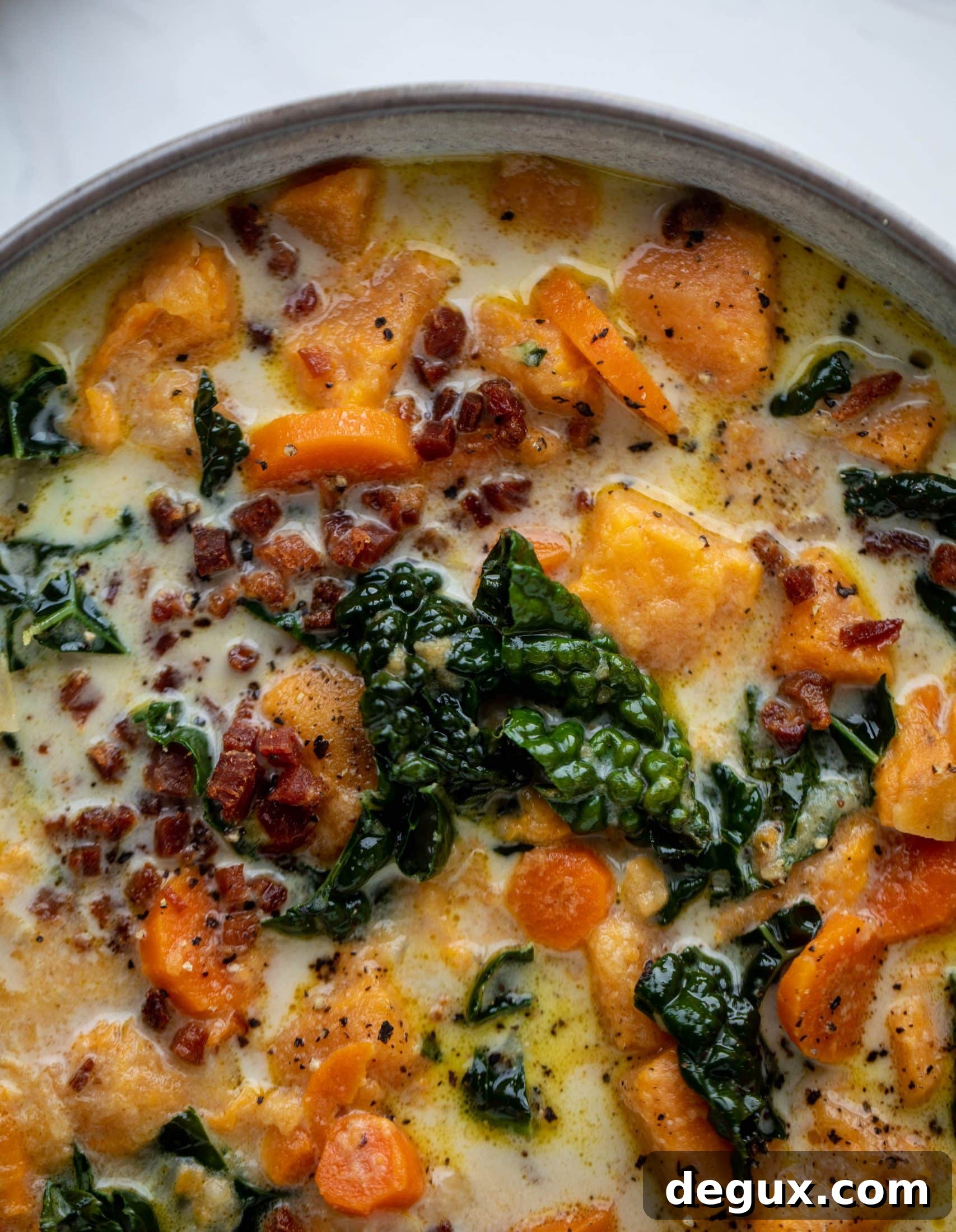 This sweet potato chowder is a hug in a bowl! Made with lots of greens and crunchy pancetta and pepitas for topping, it's a perfect weeknight meal.