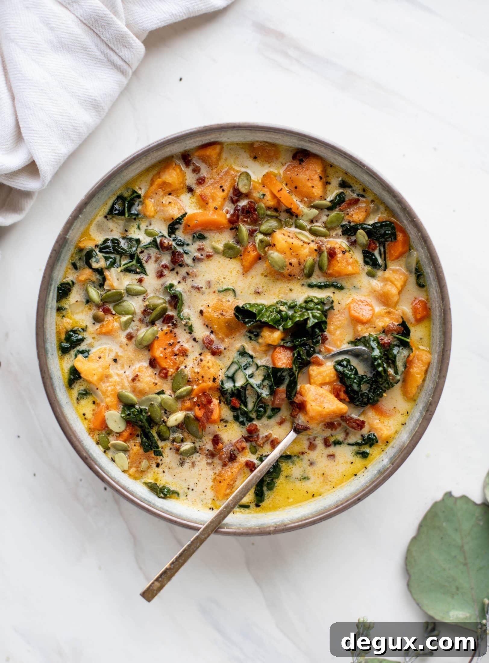 This sweet potato chowder is a hug in a bowl! Made with lots of greens and crunchy pancetta and pepitas for topping, it's a perfect weeknight meal.