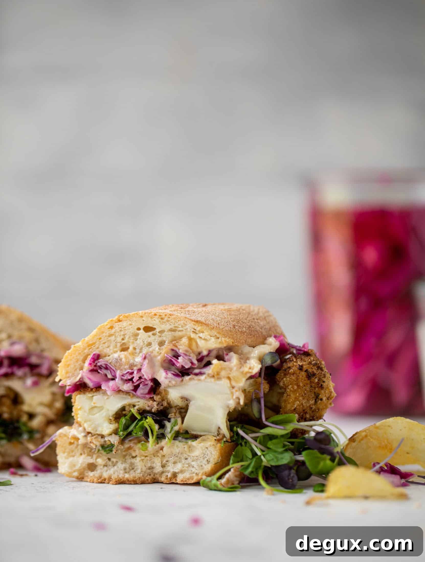 Cauliflower Schnitzel Sandwich with Caramelized Onion Mayo 9 These cauliflower schnitzel sandwiches are full of flavor! Crispy cauliflower, caramelized onion mayo, pickled cabbage and microgreens. Delish!