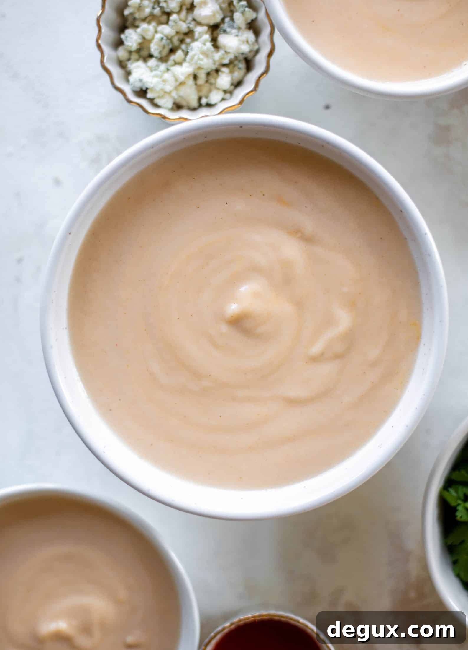 This buffalo cauliflower soup is creamy and decadent and silky smooth! Made with cheddar, wing sauce, blue cheese and all the fixins!