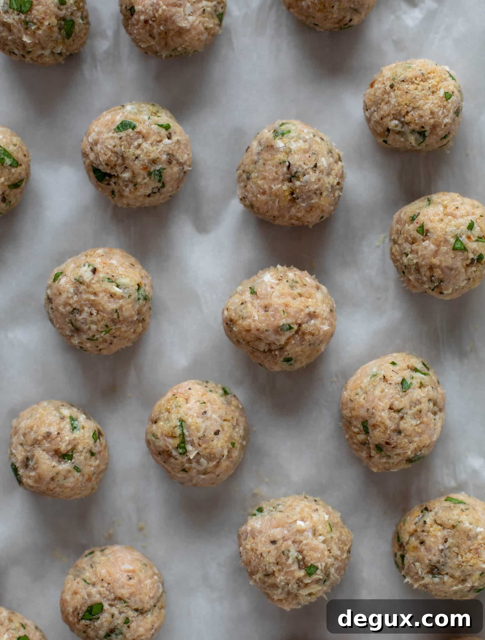 Chicken parmesan meatballs are baked and super flavorful! Serve with roasted garlic spaghetti for the best dinner ever! You can make them ahead of time too!