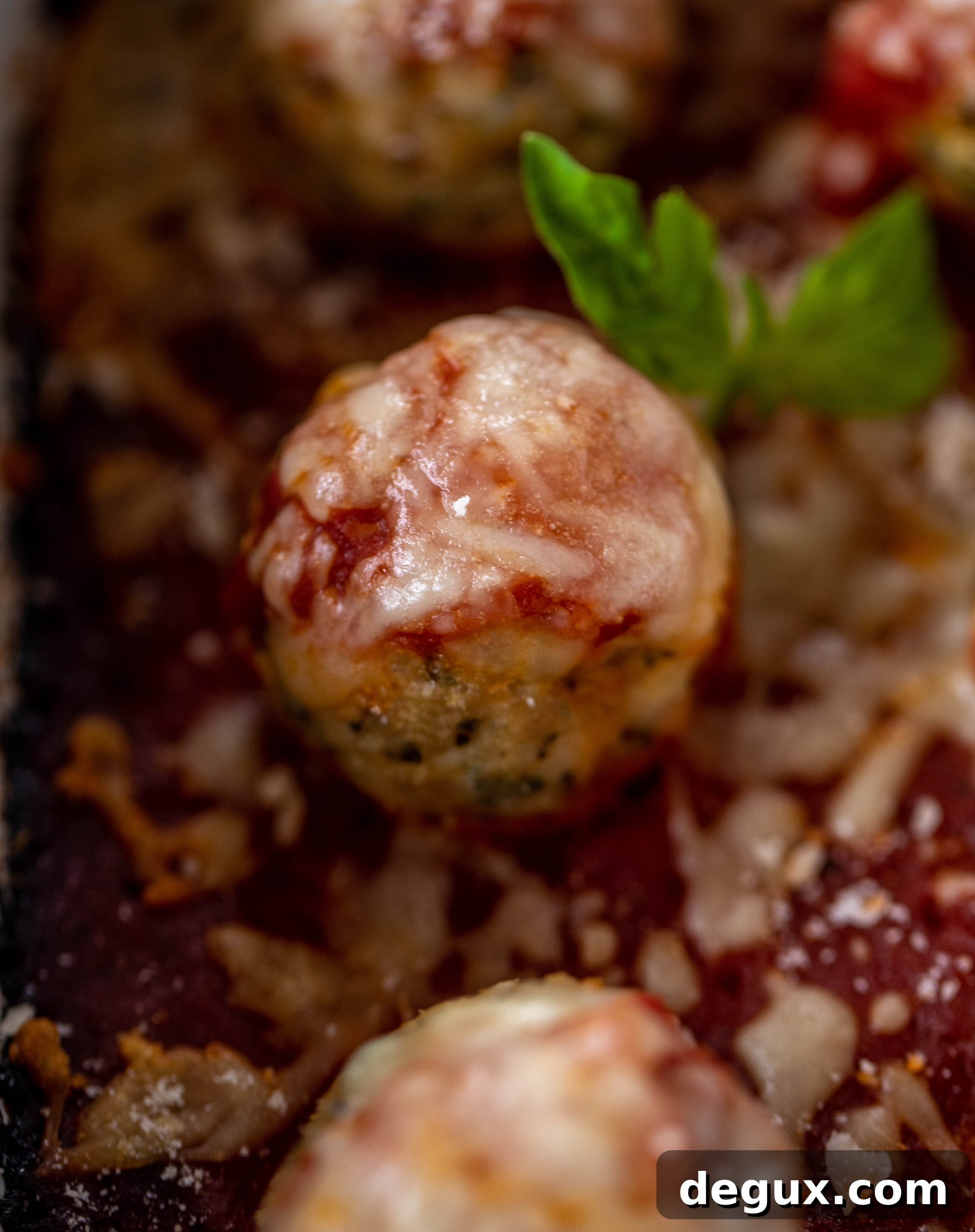 Chicken parmesan meatballs are baked and super flavorful! Serve with roasted garlic spaghetti for the best dinner ever! You can make them ahead of time too!