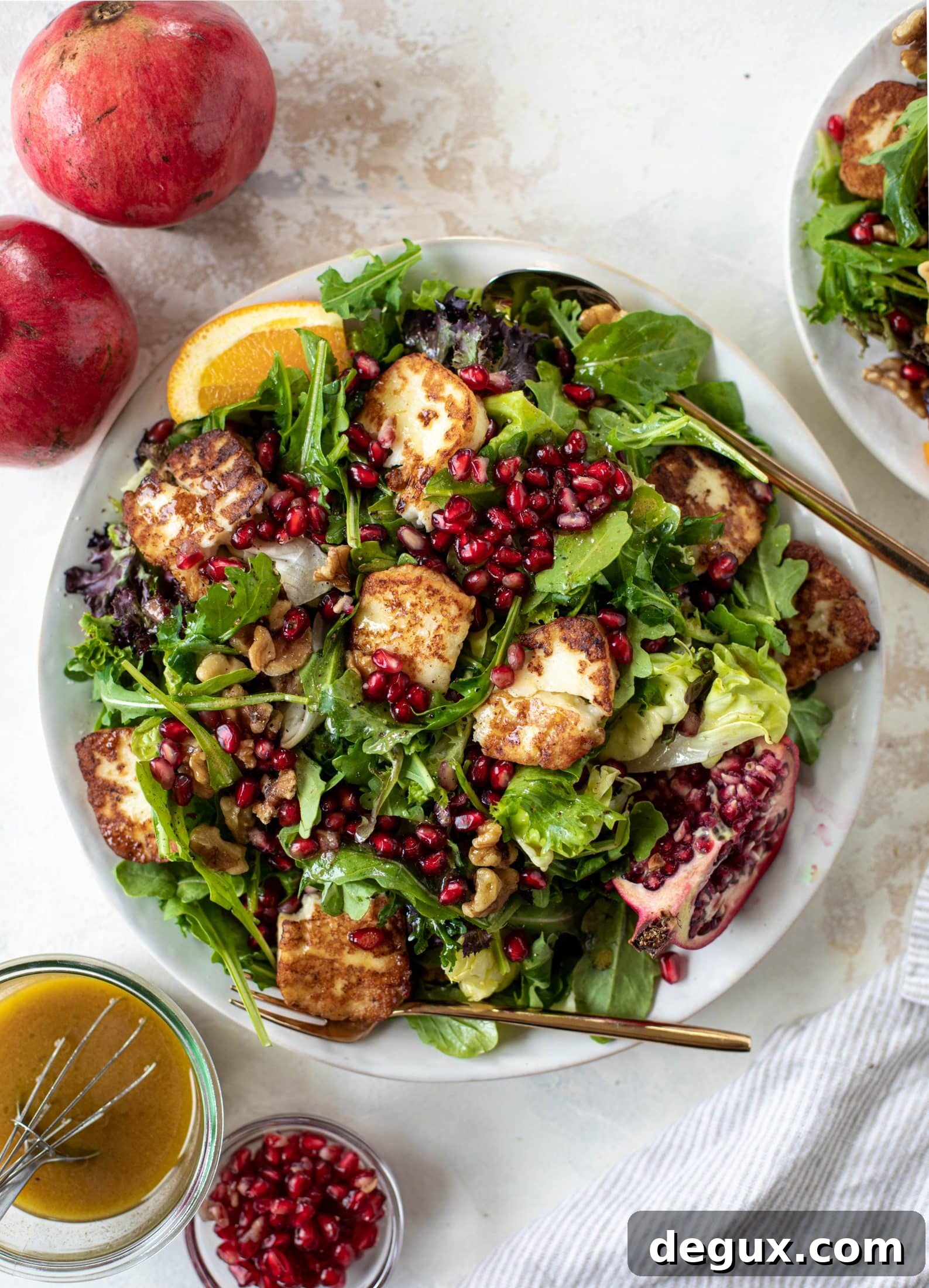 A pomegranate halloumi salad that's the perfect starter to your holiday meal! Drizzle with a spiced orange vinaigrette for the most festive flavor ever.